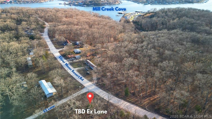 If you’ve been wishing for extra space near the lake for a shop, man cave, or storage building, this is the opportunity that finally makes sense. Located off P Road in Gravois Mills, this flat, usable land parcel sits just off the lake and offers a rare chance to add functional space close to the water. The land is flat and build friendly, making it a great option for a new build, guest house, or secondary structure to complement nearby lake homes. The location is excellent with close proximity to Mermaid Cove Marina & RV Resort, Lake Burger, and Mill Creek Cove, making it especially ideal for nearby homeowners or RV owners who need additional storage. This setting keeps you near the lake while still enjoying easy access by road. The property offers road frontage along Silver Moon Resort & EZ Lane Rd, adding flexibility for access and future use. Practical, versatile, and increasingly hard to find, this property delivers the kind of convenience that enhances lake life without the lakefront price tag.