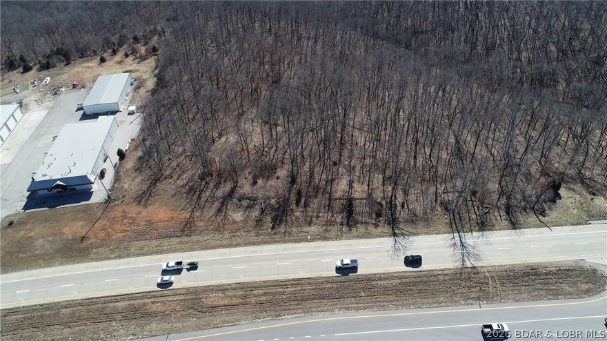 Prime Highway 54 Commercial Opportunity – Osage Beach. Outstanding opportunity to own high-visibility commercial land on Highway 54 in Osage Beach, one of the most traveled corridors at Lake of the Ozarks with approximately 20,000 vehicles passing daily. This highly visible property offers over 840 feet of Highway 54 frontage and 11.62 acres (per appraisal), providing exceptional exposure and development potential. Zoned B-2 (General Commercial) in Camden County, the property supports a wide range of commercial uses and is surrounded by established, active businesses including HMI and nearby Executive Offices, with Mi Gusto Es Mexican Restaurant located directly across the highway. The site also benefits from both eastbound and westbound access to Highway 54, making it easily accessible for customers and deliveries. Ideally positioned between Osage Beach and Camdenton, this location provides strong traffic counts, excellent visibility, and flexible development opportunities for retail, office, hospitality, or service-based businesses. Possibility of being annexed into the City limits with access to water and sewer. (Call for details) Agent owned.