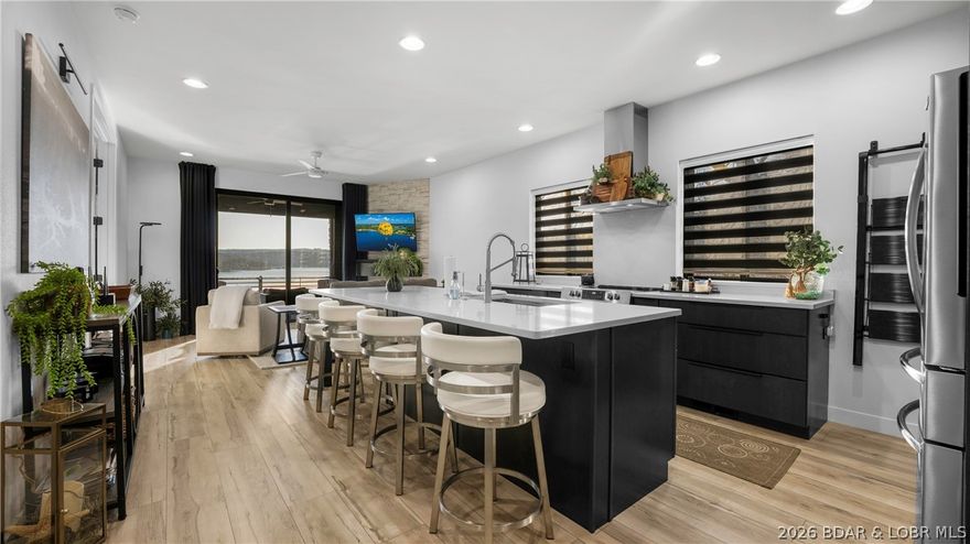 Modern lakefront villa with clean design, functional layout, and care-free living. This 4 bed, 5 bath home (2 half baths) offers 2,250 SqFt with NE facing exposure for beautiful morning light. Featuring main level living, the walk-in level includes the kitchen, dining area, living room, primary suite with lake views, laundry room, and a guest half bath. The kitchen showcases quartz countertops, stainless steel appliances, and custom modern cabinetry. Nine-foot ceilings on both levels create an open, airy feel throughout. The lower level offers a second living space, bunk room, second laundry area, guest half bath, and two private ensuite bedrooms. Both levels feature screened-in patios with plastic coverings to trap heat in the winters, providing ideal indoor-outdoor living and year-round enjoyment of the lakefront setting. Additional highlights include a heated 2-car garage and access to a large community pool and grilling area shared by only three owners. Bunk room is a nonconforming bedroom - acts as a bedroom but no door or window. With its sleek finishes, thoughtful layout, and low-maintenance lifestyle, this villa is ideal for full-time living or a lakefront retreat.