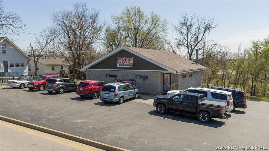 Located in the heart of Camdenton just behind the Camdenton Square, this turnkey opportunity includes both the established Firestation Bar & Grill business and the 1,817 sq ft building it operates from. Positioned in a central, high-visibility location with easy access, the property is currently functioning as a successful restaurant/bar and is fully equipped for its next owner to step in and operate immediately. The building features two restrooms, a fully outfitted kitchen with all appliances included, a newer freezer addition for expanded storage capacity, and all tables and chairs conveying with the sale. The layout offers a welcoming dining and bar atmosphere with flexibility for continued restaurant use or future business concepts. Whether you’re an investor or an owner-operator looking to expand, this is a rare opportunity to purchase both the real estate and the business in one package.