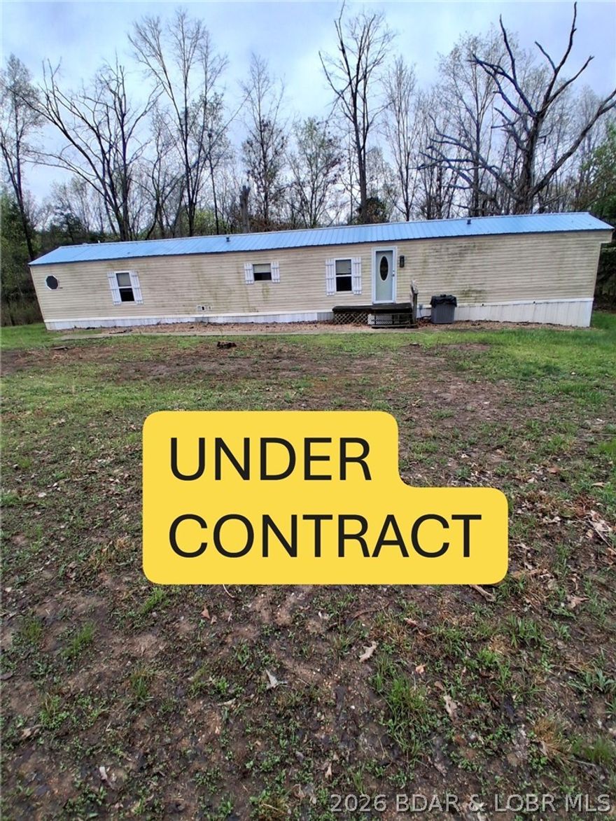 NICE, LARGE-  3 Bed, 2 Bath 1,216 sq ft (1997) manufactured Home (16x76') on 4 private, wooded acres (GREAT DEER HUNTING!) yet so close to the town of Climax Springs (less than 1 mile) where you'll find **EVERYTHING YOU NEED** for weekend or FULL-TIME Living! Home has Central Heat and Air (and propane) FIREPLACE. Private Well and Septic AND Newer METAL ROOF. Wood Floors and extra wood working trim throughout. Eat-in Kitchen has easy-care Vinyl floor. Clean, Clean Clean-MOVER-IN READY *All KITCHEN APPLIANCE INCLUDED*.WASHER & DRYER INCLUDED, too!  Outside you'll find a 'Free-Standing' Carport and a 'Modern' STORAGE Shed (approximately 6'x12' with loft for storage). With this home, you get the "Best of Both Worlds"- Country living & City conveniences AND ...walking distance to School.... at a very a reasonable price!  See pictures and call for a tour today!