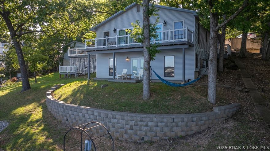 Investment Opportunity Alert!  This outstanding nightly rental located in the heart of Osage Beach on the 20 mile marker has several unique features that make it an excellent rental, but the fact that all 4 bedrooms have a private bathroom &shower within each room is the feature that most renters love. Sure, there's 177' of shoreline & main channel views from the property while still located in a protected cove, over 500 sq. ft. of decks where one can catch an awesome sunset, a 2 well dock with 3 PWC Shore ports, three kayaks, a lily pad, & a swim platform, 8 smart TVs scattered throughout the place & plenty of off-the-street parking, but people always seem to go back to the 4ensuites on that main level. The walkout basement is now a bunkroom and from there, it's a short walk to the dock or the hammock that is near the bottom deck. There are two washer / dryer hookups on the main level should an owner want to have two stackable sets going at the same time and with the propane fueled tankless water heater, there's always hot water. This property is being sold completely turn key & "As Is" & the possibilities with this property are endless.  Come take a look!