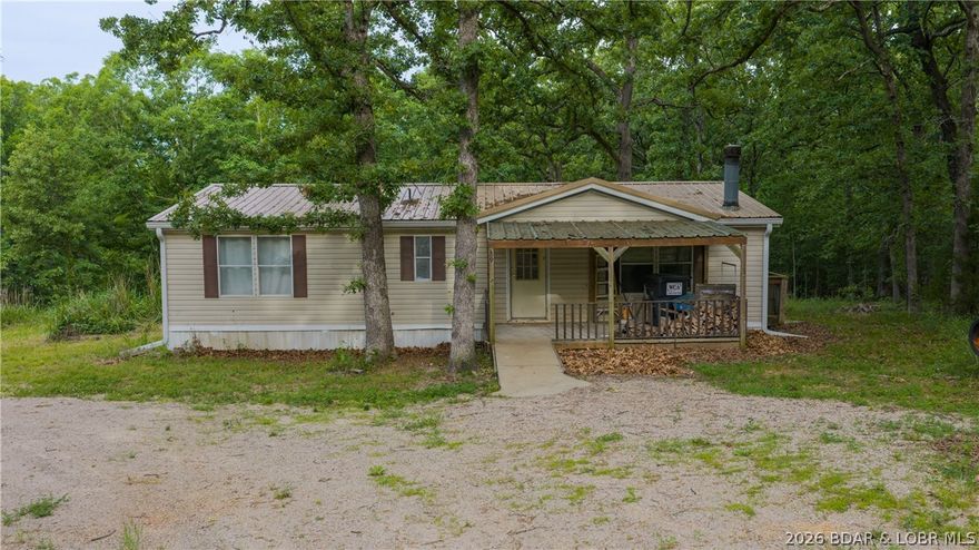 Rare opportunity to own 6.6 acres of beautifully wooded privacy at Lake of the Ozarks! Located between Osage Beach & Camdenton & just 2.6 miles from Hwy 54 down A Rd, this unique property offers two adjoining parcels w/endless possibilities for your dream home, private retreat, investment property, or family compound. Both parcels feature established homesites w/shared well access & electric already installed. One 3.02-acre tract includes a modular home w/a new septic system that just needs a few repairs & your personal touch to transform it into your own secluded piece of heaven. The adjoining 3.6-acre parcel features another homesite w/septic & a mobile home currently on the property that is in rough condition & may need to be removed unless you’re handy & ready for a project. Enjoy peaceful country living surrounded by nature while being just minutes from shopping, dining, entertainment & all the Lake Life attractions the area is known for. With plenty of room to build a garage, workshop, man cave, additional home, or simply create the ultimate getaway, the possibilities here are endless. Whether you’re looking for privacy, space, or investment potential, this property delivers!