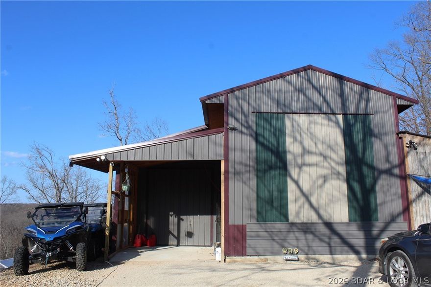 The hard part is already started—20.5± acres with utilities in place and a prime homesite ready for your vision. The land features gentle rolling hills, cleared areas, trails, and a weathered creek running through the property. At the top of the hill near the road is a cleared building spot overlooking the acreage below. Right next to it sits the garage, which serves as the main utility hub and includes the well house, washer/dryer hookups, water heater, and a high-end water softener. The garage also has its own electric and septic already connected. Inside is a 2020 Forest River Arctic Wolf fifth wheel, offering a comfortable place to stay while building or enjoying the property.  Down the hill sits an insulated yurt with septic and electric already connected, along with a 1,000-gallon water tank and pump system.  Additional features include a storage shed, shipping container with 7 windows and 5 sliding glass doors still in the box, a 2025 Kioti tractor, and a 2021 side-by-side. With two nearby boat ramp options, you can enjoy lake access while still having the privacy of your own acreage. Perfect for a homesite, weekend retreat, or private getaway.