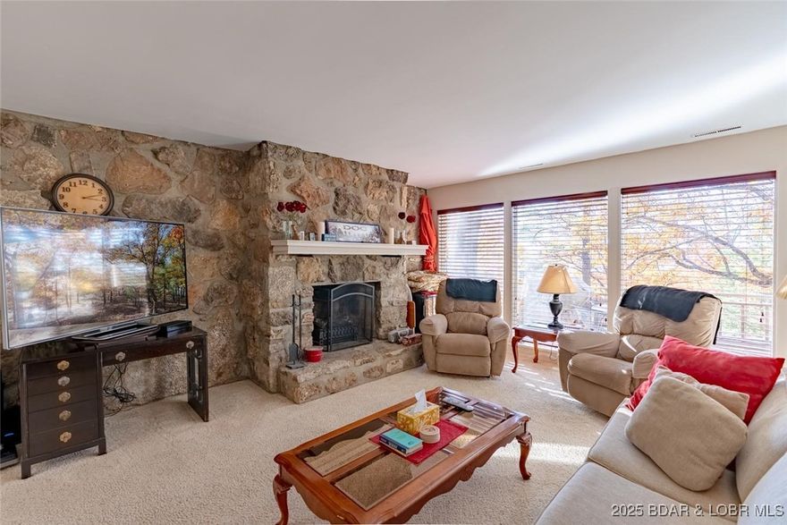 Enjoy lake living without the lakefront price tag in this inviting 3-bedroom, 3-bath condo nestled at the end of a quiet cul-de-sac. Surrounded by nature yet just minutes from Osage Beach dining, shopping, and entertainment, this location offers the perfect blend of privacy and convenience. The open main level features a spacious living area with a striking natural Missouri stone accent wall and electric fireplace, creating a warm, comfortable homey feel. The dining area includes a convenient laundry closet and flows effortlessly onto a large deck with seasonal lake views—an ideal spot for morning coffee or casual gatherings. Upstairs, the vaulted ceilings enhance the bright layout, keeping all bedrooms together for added convenience. The primary bedroom offers access to its own private deck, providing a peaceful retreat. The lower-level deck offers an additional space for entertaining, grilling, or simply relaxing outdoors. Whether you’re seeking a full-time residence or a weekend getaway, this condo delivers easy, low-maintenance living with great amenities—including a community pool, pickleball court, and tennis court. A fantastic opportunity in an unbeatable location!