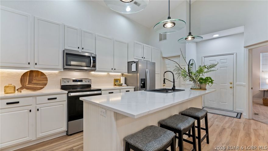 Morning starts in the sunroom, filled with natural light and a quiet moment before the day begins. Coffee in hand, you start thinking about what’s next—maybe a round of golf, a few hours by the pool, or heading over to the tennis or volleyball courts. Later, grab dinner at The Trophy Room or Hook Café, relax at the spa, or enjoy seasonal touches like the ice rink. Everything is close, easy, and ready when you are. Inside, the space opens with a seamless flow into the great room, where a stone fireplace and comfortable seating create a warm, inviting place to gather, all connected by an open layout. Soaring ceilings and high-end furnishings add a sense of openness and a luxurious feel throughout. The kitchen is thoughtfully updated with an oversized quartz island, new tile backsplash with built-in power and USB outlets, stainless appliances, and a dedicated coffee bar. Everything is designed for effortless, single-level living, with 2 bedrooms plus a separate office behind French doors that easily serves as a third sleeping area. Fully furnished down to the decor and beautifully finished throughout, this is a home that feels just as good as it looks the moment you walk in.