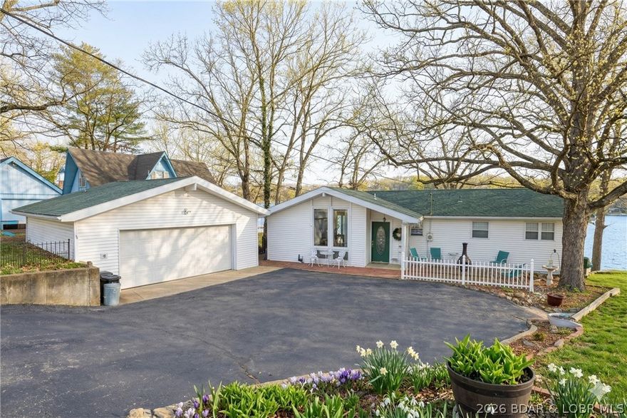 Darling lakefront GEM, cherished by one family for years is now ready for your memories to begin. Perfectly positioned on a RARE GENTLE lot with main-level living & endless lake views! Inviting open floor plan features vaulted ceilings & walls of windows that flood the home with natural light. Generous lakeside primary suite features a sunroom, ideal for morning coffee or extra living space. The lower level is perfect for guests, featuring a family room, kitchenette, two guest bedrooms (1 no window), a full bath, & laundry. Mezmerizing lake-views to behold while building lasting memories. Spend hours on the lakeside deck & patio watching the boats go by. Gaze to the bluffs across and watch wildlife. Generous dock envelope with aprox. 95 ft. of waterfront. New HVAC system in 2025 adds peace of mind. Shady Slope is loved by owners for the huge common lot, let the yard games begin! This lovely home is in a wonderful neighborhood surrounded by upscale homes. Pefect location at the 23MM in Osage Beach close to numerous  restaurants, shopping, the hospital, and all of the Lake's best destinations by land and water. Capture this sweet lakefront property and make it your own!