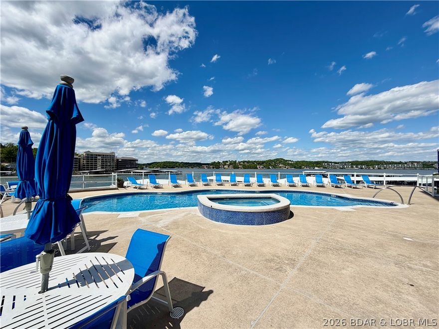 Watch the sunrise over this amazing view from your TURN KEY Monarch Cove investment- recent updates include a BRAND NEW HVAC system (coming May 2026) and attention to detail in ownership means you'll have a worry free vacation spot right in the middle of the Lake of the Ozarks action at the 2 mile marker of the Main channel. Cove protection for the docks, these owners UPGRADED to a 12x36 slip for your watercraft, a spot for your Jet Ski or waverunner, multiple pools in the complex- one just down the elevator from your unit on the way to the boat slip which is also extremely conveniently located. Stainless steel appliances, screened patio so you actually enjoy sitting outside, a Jetted tub in the main suite, droolworthy lake views from the entire living space and main suite, this place is just around the corner from so many conveniences, you'll never wanna check out!  Extra PWC slip, Garage space, 15k lb lift and even a boat are available all for extra cash- come plug in here for the ENTIRE lake experience!