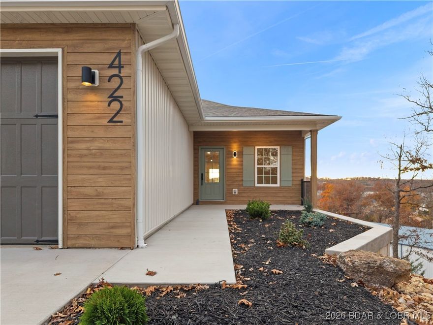 Experience elevated lake living in this new construction villa, offering lake views, quality craftsmanship, and exceptional space, comfort, and convenience. With 4 bedrooms, 3.5 bathrooms, and 3,718 sqft across two finished levels, this home is designed for both luxury and everyday ease. The main floor offers 1 level living and features: stunning master suite with his-and-hers walk-in closets, dual vanity, a gorgeous walk-in tiled shower, a large standing tub, and direct access to the laundry room. Enjoy an open-concept living area with a 60-inch electric fireplace, a gourmet kitchen with gas stove, a convenient half bath & bonus room could be used as office space. The lower level is ideal for entertaining, offering three bedrooms—including one private ensuite—a full bath, a spacious family room, a game room with wet bar, and a utility room. Finishes include quartz countertops, laminate flooring, carpeted bedrooms, and stylish tile for added comfort. A large finished two-car garage provides room for an extra vehicle, golf cart, or storage. Includes boat slip in community dock- this villa blends function, design, and lakeside luxury—delivering the perfect lake lifestyle.