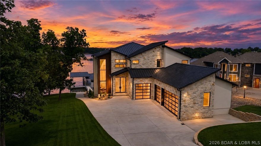 The nicest home in the most upscale subdivision at the LOZ! This ~10,000SqFt masterpiece IS COMPLETED & will leave you in awe. Centrally located on the 21MM near Redhead, Shorty Pants, & PBC. It sits on an exclusive flat, cove protected AND main channel view lot!!!   This exclusive home presents 6 bedrooms(each are ensuites), 8 full baths, 1 half bath, a 2 tiered salt water gunite pool, massive new 2 well boat dock(16x50 & 12x34 ft slips), elevator, floating staircase, & gentle lakefront lot. The exterior consists of stucco, NewTechWood, & native Kansas limstesone & marble quality limestone. The main level offers 2 ensuites, the kitchen, living, dining, & laundry rooms, & 10 ft collapsible sliding doors. Venture upstairs for 3 ensuites, bar, & a half bathroom. The lower level has a living area, golf simulator room, wine room, lakeside ensuite, storage, & walks out to the pool. Upgrades include Sonos wired speakers throughout, 4 car heated/cooled garage(fit 8 w/ lifts), each level has stamped concrete patios, Viking appliances, Quaker aluminum windows, Napoleon electric fireplaces, & was designed by ML Designs(KC's top interior designer 2022-24). Tour it today!
