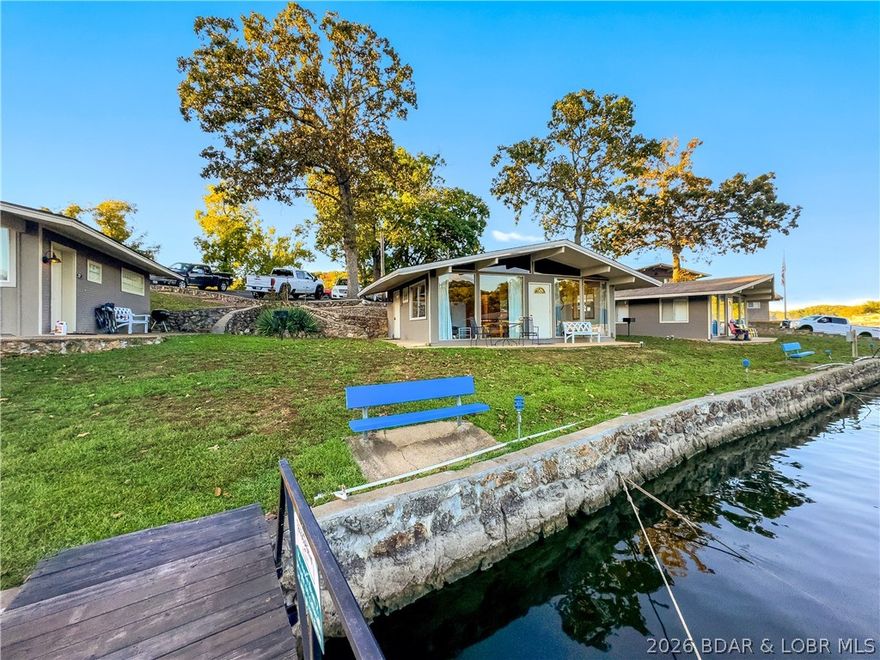 BASS POINT RESORT Lake Cabin with a Dock Slip. Great Rental History and comes Turn-Key ready to enjoy. All the benefits to owning your Lake Home. Close to the Community Pool, 2 Bedroom/1 Bath, Vaulted Ceilings, Laminate Flooring in Bedrooms, lots of Lake View Windows and a Lake Front Patio to enjoy the Lake. Easy walk to the Dock Slip & community lakefront. Amenities include Laundry Facilities, Club House with Rec Room for gatherings, Arcade, 2 Pools (1 indoor & 1 outdoor), Tennis, Pickleball & Basketball Courts, Playground, Swim Dock, Boat Ramp, outside Fire Pits and much more. Home is on a successful Rental Program for extra income. Classic "Lake Cabin" less expensive than a Condo & doesn't have the high HOA fees.