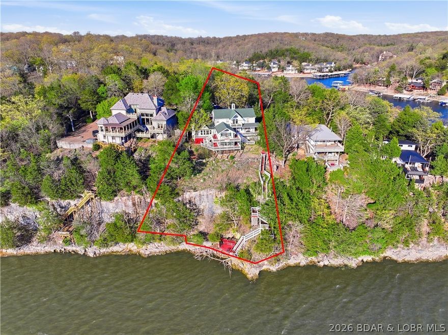 Step into a one-of-a-kind opportunity at the Lake of the Ozarks with this stunning Victorian-style home, formerly an original bed & breakfast and now a thriving vacation rental. Boasting 7 bedrooms and 4 private suites, this property is perfectly designed to host large groups while offering individual privacy—making it a proven income-producing investment. Perched on a scenic bluff, the home captures breathtaking sunset views over the main channel, creating an unforgettable backdrop for guests and owners alike. Enjoy direct lake access with the potential to add a dock, enhancing both value and convenience. This turn-key property comes fully furnished and ready to continue its success as a short-term rental or serve as a luxurious private retreat. Ideally located just minutes from Margaritaville and other popular lake attractions, you’ll love the blend of charm, history, and modern income potential. Whether you're an investor seeking strong returns or a second-home buyer looking for something truly special, this property delivers unmatched character and opportunity at the lake