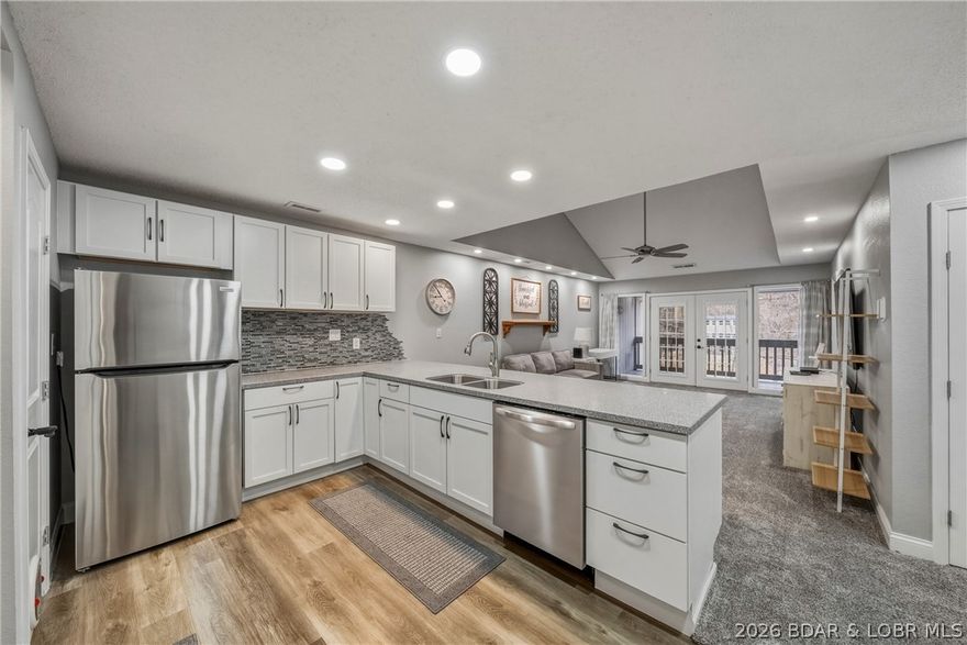 Not your ordinary unit at Eagle Bay in the heart of Osage Beach. The only unit with vaulted ceilings in complex.  Original owner vaulted the ceiling in Living room for more open feel and made room for a full-size walk-in closet in the master, so either seasonal or full-time ownership gives you ample space! And... only 7 steps into this beautiful TOP FLOOR unit!  The complex is quiet with only 24 units and has assigned parking.  New flooring, new HVAC - new dishwasher, and the newer appliances were rarely used.  The no wake cove is perfect for family fun in and out of the water.  Hang out at the community pool that is surrounded with huge deck and enjoy your family and friends.   Boat slip is 10x28 and is included -  the 10,000 lb. lift only 6 years old is negotiable.   HOA owns lower lot for trailer parking and there is private boat ramp!!!  Minutes from grocery store, restaurants, golf and shopping.  This complex is well maintained with low HOA dues - everything you need to start your love of the lake in this unit! OFFERED TURNKEY!  Don't wait!