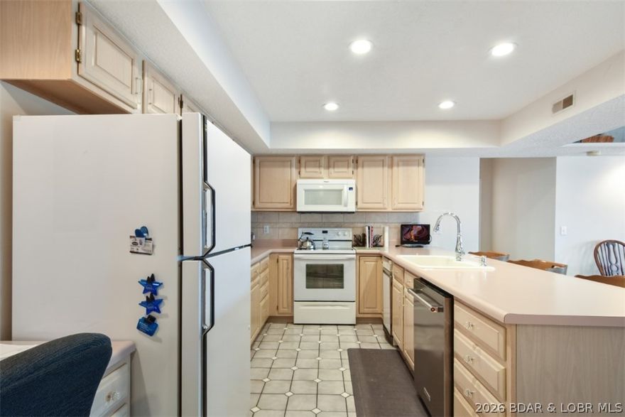 This isn’t your typical shotgun-style condo; it offers the spaciousness and privacy of a single-family home. The layout features two lakeside primary suites, a dedicated dining area, and a functional galley kitchen. The standout feature is the 54-foot fully screened deck, providing expansive views in both directions and a rare level of outdoor living space. Modern updates have already been handled, including a newer HVAC system with humidifier, water heater, and updated kitchen appliances. High-end, oversized Pella sliders provide sound-deadening insulation, leaving only your personal cosmetic touches to be added. Convenience is built-in with two garage parking spaces located right outside your entrance, and steps from the elevator, which takes you directly down to the docks. Sold "as-seen," this unit comes mostly furnished and fully equipped with all appliances, decor, and housewares included. This isn’t just a condo; it’s a residence designed for comfort. From the moment you step inside, the layout offers a welcoming, house-like atmosphere that immediately feels like home. Schedule a showing today and see how easily you can envision your life here.