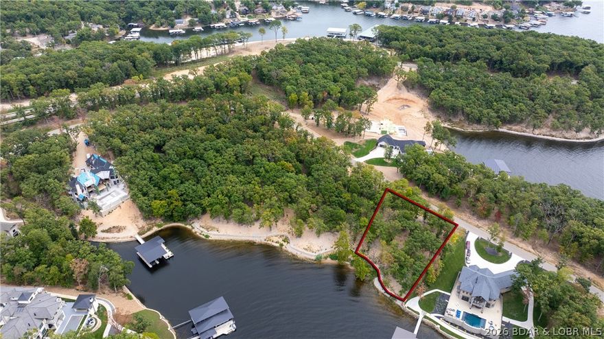 If you want the most exclusive address at Lake of the Ozarks, this is it! This peninsula in the Villages is quickly becoming known as "the ultimate lake address" With over an acre of gentle terrain and 220' of beautiful shoreline, the possibilities are unlimited. Large dock envelope is perfect for the dock of your dreams. Multi-million dollar homes are being built all around this spectacular setting. Everything you need is just across the community bridge. Only minutes from fun activities on Bagnell Dam, multiple groceries stores, shops, restaurants and medical facilities by land offers convenient living. Hop in the boat and you can be at multiple water entertainment complexes including Dog Days, Redhead Yacht Club, Backwater Jacks and for that fine dining experience check out the Reserve! Combine this with the adjacent lot and you have a place to build your lake masterpiece! Don't miss the opportunity to own one of the last premier parcels at the Lake.