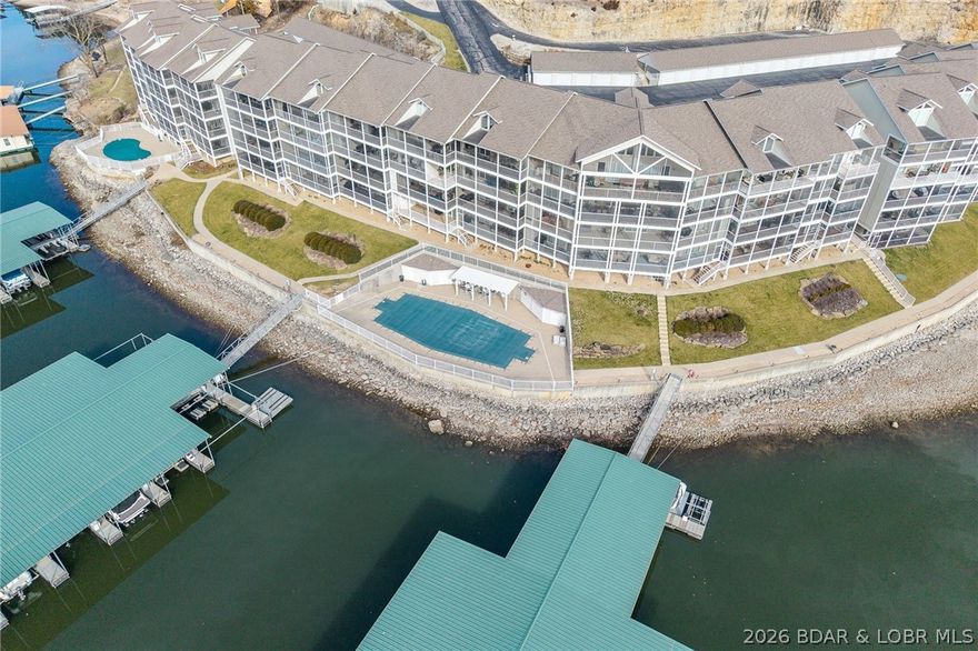 Rare opportunity to own a 3-bedroom, 2-bath WALK-IN condo located at the 38 Mile Marker on the Lake of the Ozarks. This desirable unit features modern finishes and has been well maintained, offering a clean, move-in ready interior. Units at Windgate on the Lake do not become available often.

True walk-in access with no stairs from parking to the unit. Elevator service also available for convenient access to the docks and community pools.

Spacious layout with open living and dining areas, large bedrooms, and generously sized bathrooms. Expansive glass windows and doors provide abundant natural light and enhance the open feel of the home. The large screened-in deck offers additional outdoor living space and a comfortable area to relax and enjoy the lake setting.

Includes Dock B, Slip 11, and Garage #17. Community amenities include two swimming pools. Suitable for full-time living or a lake retreat.