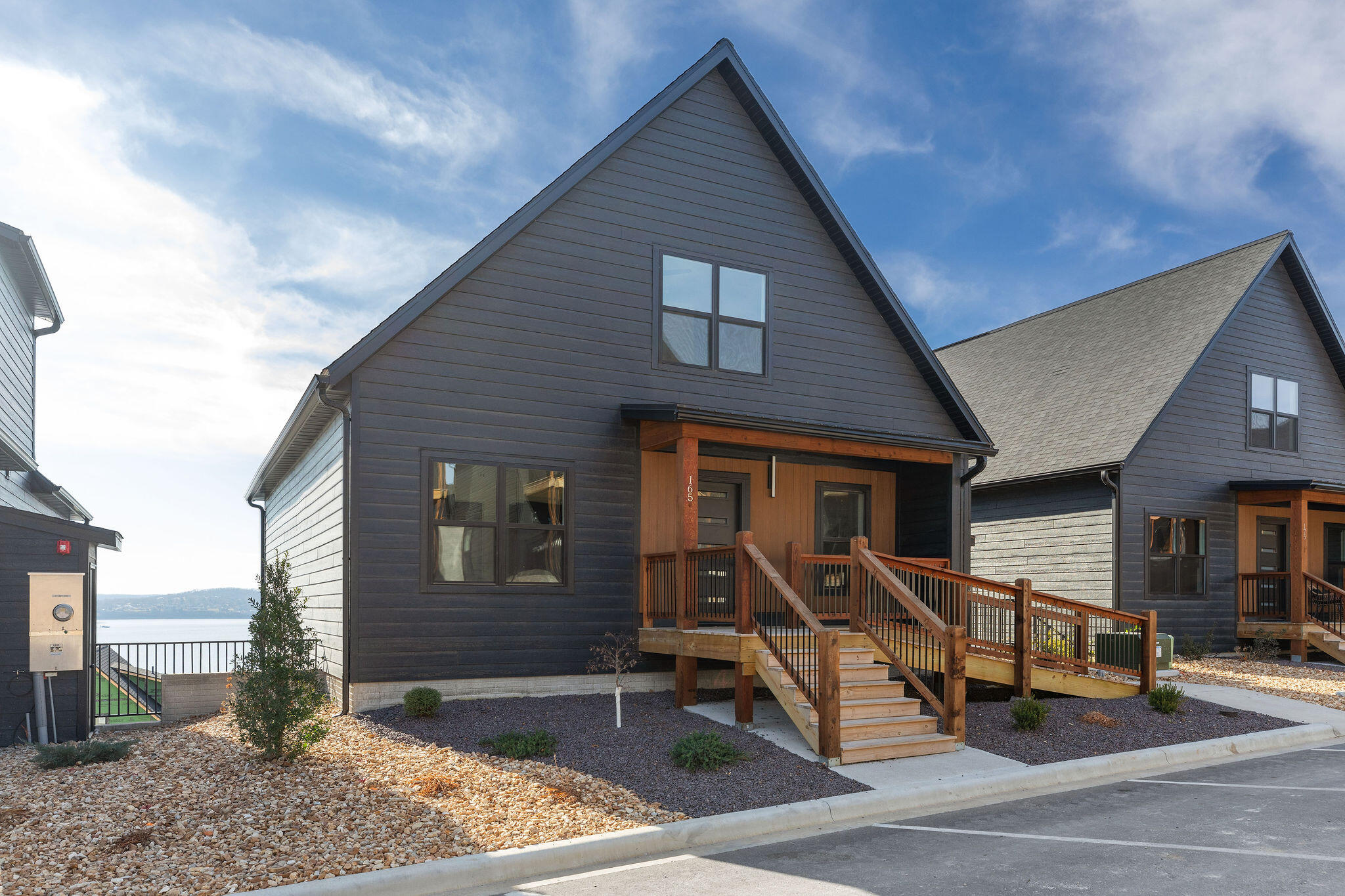 Surprise! The LAST remaining new construction lodge at Rocky Shores Lodge, and it's a STUNNER! 6 bedrooms, 6 baths, 3150 SqFt, and OUT-OF-THIS-WORLD VIEWS!! Three levels, two living areas, en-suite baths, two large decks, and a RARE vaulted ceiling upgrade that just gives the great room WOW factor! What a fantastic community, too! Rocky Shores Lodge is ideal for short-term rental. A master-planned community of lake homes has a reimagined design intended to create a unique and exclusive resort experience while maintaining the flexibility of individual unit ownership. Fabulous indoor and outdoor pools in the community. No restrictions regarding management - hire a pro, or do it yourself! You can see the finish quality of this community stand head and shoulders above the rest! Ideally located just south of Branson off Hwy 65 - half way between Branson Landing and world famous Big Cedar Lodge. Rocky Shores Lodge shares the same cove with the fabulous Top of the Rock.
