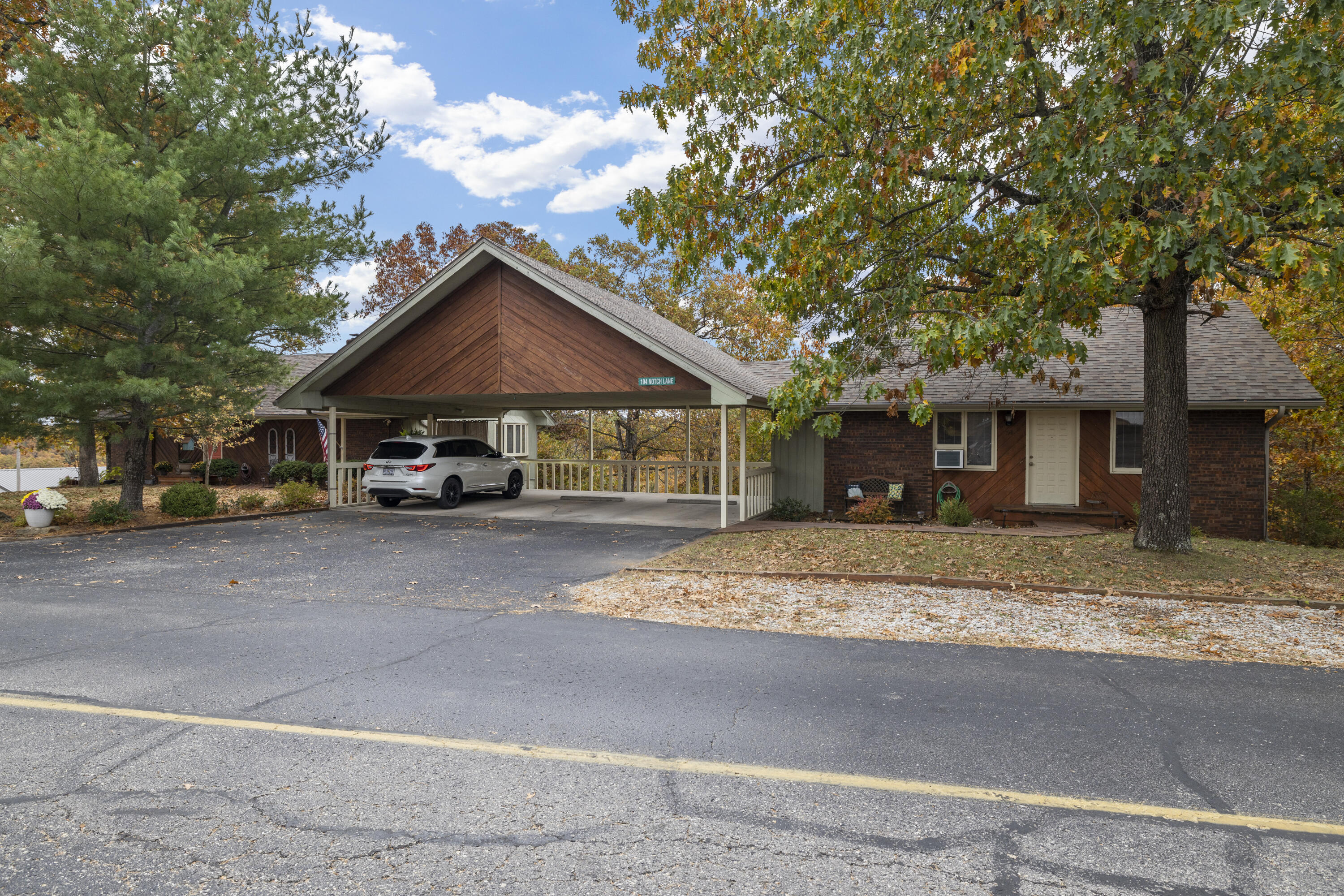 Not often can you find Two Beautiful Homes on one lot AND you and you can live in one and short-term rent the second home.  Or because Stone County has rezoned and approved to put both on your own nightly rental program, you can use this as your best investment property in this area.  Location, Location, Location comes to mind when you have such a quiet location on .88 acres just 1/2 mile from Silver Dollar City.  MAIN HOUSE:  4 Bedrooms, formal dining area, laundry room, art studio/craft room or office, 2 1/2 baths and the heart of the home features an open concept living area with kitchen that features a large island.  And take a look at this beautiful fireplace ready for those chilly nights.  Plus, gorgeous kitchen granite, new luxury vinyl plank flooring, new paint, new appliances, new roof - all ready for your vacation home, permanent residence or county-approved short-term rental. But that's not all! Connected by 3- car carport, your GUEST HOUSE includes 3 bedrooms, 2 baths, laundry and 3rd bedroom big enough to use as a den or large bunkroom. This guesthouse comes completely furnished, including kitchen, linens, dishes and decor.  Your guest will love the ample parking (even for boat or RV) and the beautiful outdoor area, courtyard and upper and lower decks.  The perfect relaxation area to enjoy after a long day seeing the sights of Branson.  STONE COUNTY ZONED APPROVAL FOR SHORT TERM RENTAL AND WILL TRANSFER TO NEW BUYER.  You can rent one or both homes.  Gross income for Guest house in 2022, estimate $29,000.  Main house has not been rented to date, owner lives full time in this home. Great potential for large families visiting Branson.  Both homes are included in the square footage and is approximate.  Agent/Owner is Licensed Missouri Realtor.