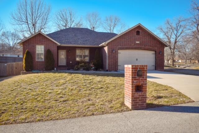 This fantastic house features an open floor plan with several upgrades that make it stand out. The living room has a cathedral ceiling and stone fireplace making it feel bright, warm and spacious. There is a lovely arch separating the living room and kitchen while maintaining the open concept. The knotty alder cabinets and granite countertops are gorgeous. An eat-in space features french doors to the back patio. The living room, kitchen and hallways have engineered hardwood flooring. The master bedroom is spacious, the master bath features an oversized tile shower with glass doors, double vanities, an additional built in vanity for when you want to sit down and a walk-in closet.  The split bedroom concept also has two more bedrooms and a full bath on the opposite side. The lovely stamped concrete sidewalk and covered front porch make welcoming friends even better. The garage is big enough for storage in the front and on both sides. The yard is landscaped, privacy fenced and the shed is included.  Don't miss your opportunity to see this great house.