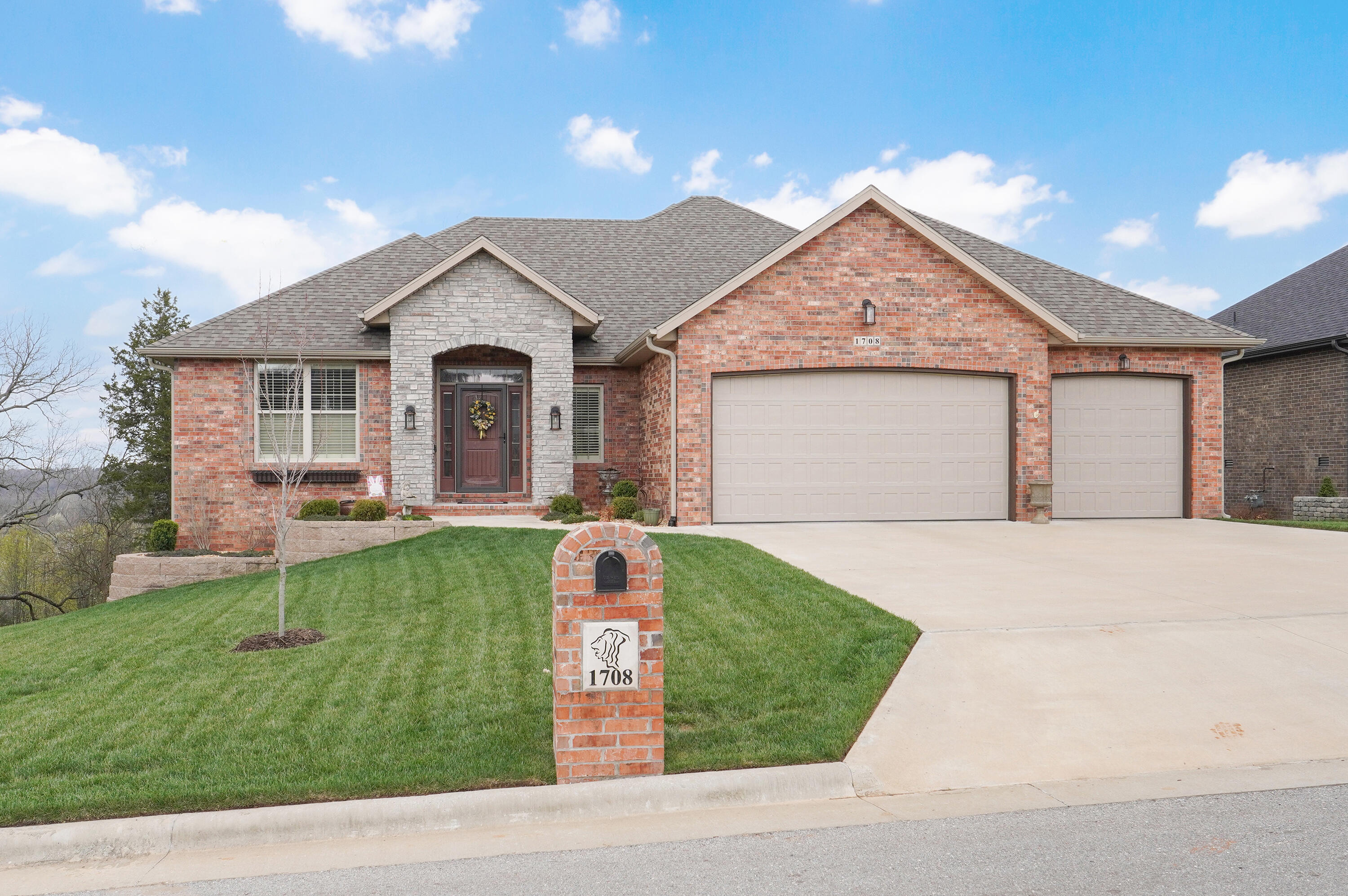 Lions Gate Gated Community, Country Setting, City conveniences...what more can you ask for? This home has an amazing view of the Ozarks from the back covered deck. From the covered back you can see all the way to Nixa with a view everyone wants to see in the fall when the Ozarks bright up to gorgeous colors. This all-brick walk-out home sits nestled up against greenspace. It offers amazing 5 bedrooms 3.5 baths, large chef's dream kitchen with approximate 9' island, walk in pantry, custom cabinets, multiple living areas, nice spacious john deere room, large 3 car garage and so much more. The house has a split floorplan with the large master suite privately away from the other bedrooms, beautiful hardwood floors, granite countertop. This home was built in 2021 you cannot tell it has been lived in. The owners are meticulous and keep it like new. The have added the following updates: tinted windows, nice rod iron deck rails, Water filtration system, storm door and stone wrapped the back columns that were wood. The window coverings include plantation shutters in part of the home. The color scheme is very neutral and will go with all types of Decors. You can  see the beautiful sunrise and the sunsets on the peaceful back covered deck overlooking the Ozark wonderful creation. This home is move in ready! Feel free to reach out for more details on this amazing home.