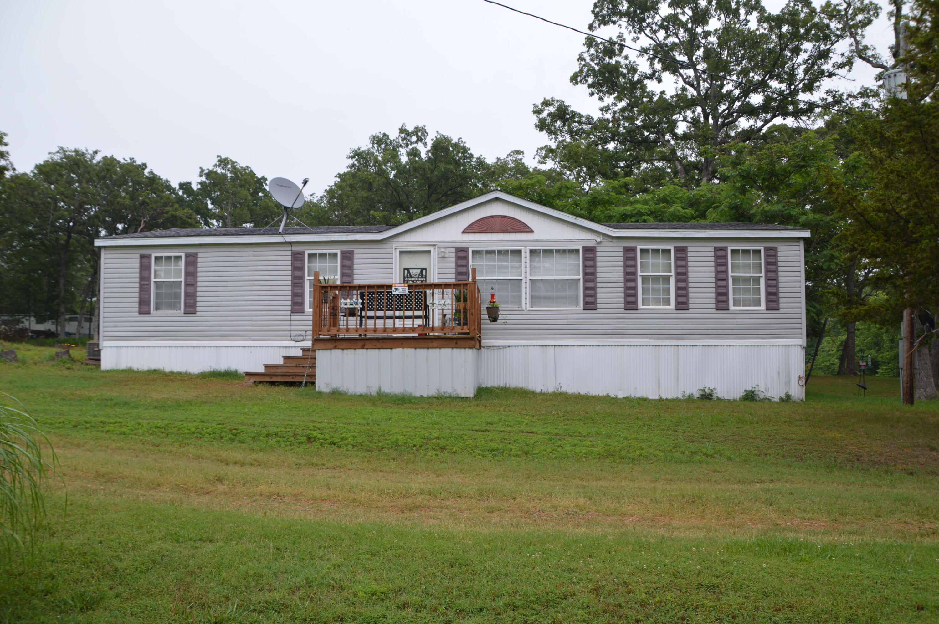 What a great fishing/retirement get away for this spacious 3 bedroom, 2 bath doublewide mobile home on 3/4 acre +/-.  2 living areas, wood burning fireplace, primary suite includes a jetted tub and double sink vanity.  Just across the street from Corps wildlife area and Osage River Arm of Truman Lake.  Turkey Creek State Wildlife area is also just down the street.