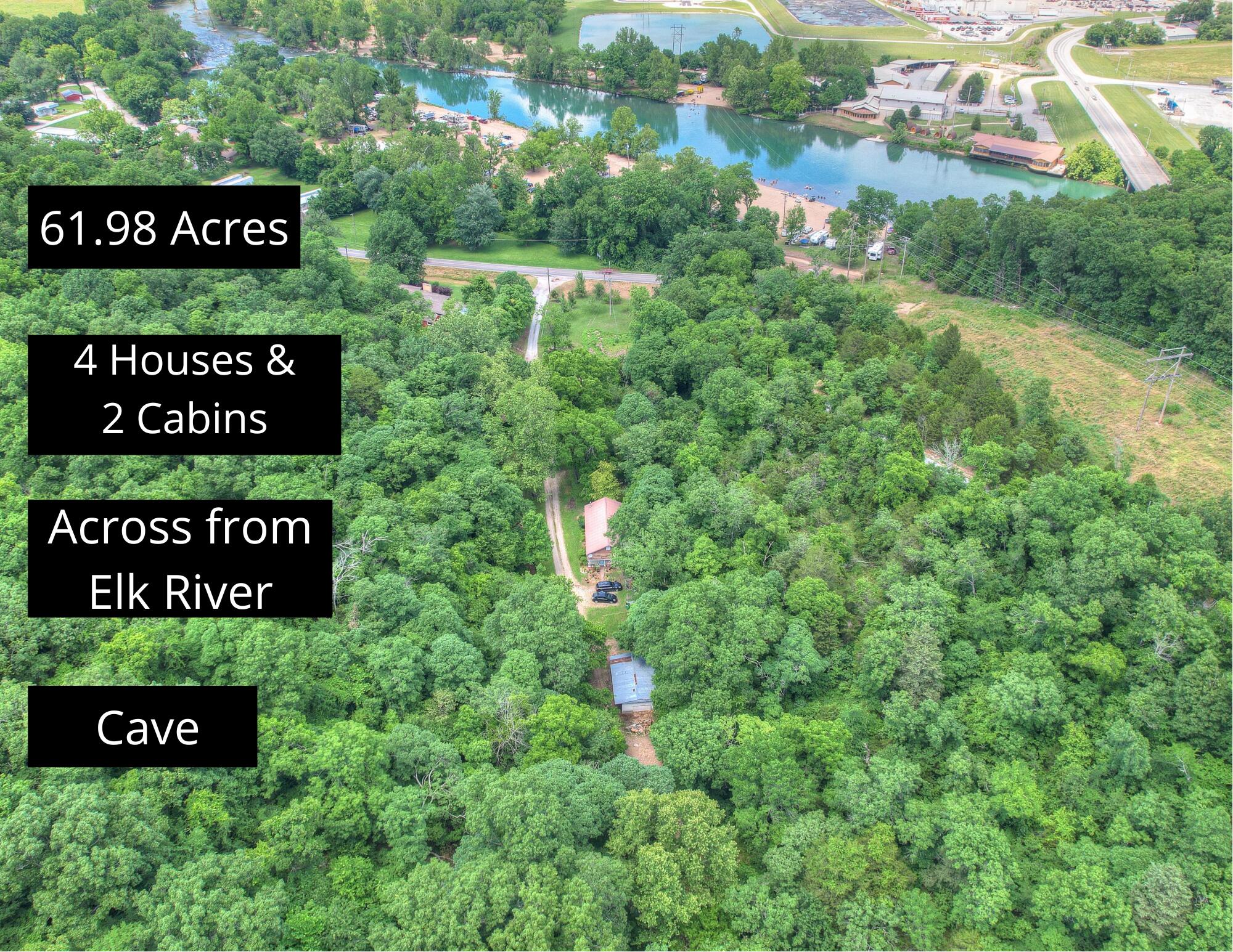 Four houses, two cabins, cave and DIRECTLY across from Elk River? Yes, please! Check out this one-of-a-kind property in Noel! This is a prime location and great spot for multiple air b&b rentals, canoe rental place or whatever you can dream up! The main house features 1788 sqft, two bed, two bath home with lots of character in every room, with an attached two car garage. Off of the garage you have a gorgeous sitting area to enjoy the beautiful nature all around. There are 2 adorable cabins, with one already rented out and the potential for TONS of income! All of this is sitting on 61+ acres surrounded by gorgeous woods and bluffs! This is a MUST see to appreciate the beauty and value! BY APPOINTMENT ONLY.