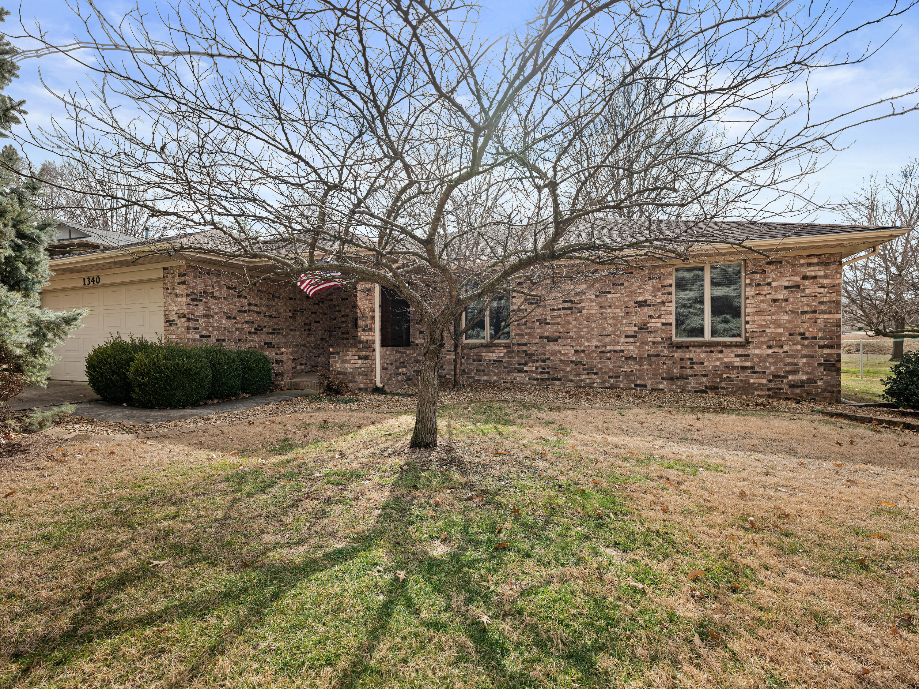 Three bedrooms, two bathrooms, and many custom features are highlighted in this all-brick home. There is a traditional foyer in this home, which can be used for welcoming guests and greeting them when they arrive. There are beautiful hardwood floors in this home, no carpet, updated windows, an updated furnace, and over 1,500 square feet. Ft. There is plenty of natural light in the living room, which is connected to the dining room. The living room has vaulted ceilings and a brick wood-burning fireplace. The kitchen has original oak cabinets in amazing condition and a laundry closet; it's spacious enough for cooking tasty meals. There is a large master bedroom at the opposite end of the house with two walk-in closets and an en-suite bathroom with a large vanity and a walk-in shower. The main bathroom is just down the hall from the two other bedrooms with large closets. Isn't it fantastic that the backyard has mature trees, a covered patio, a full chain link fence, as well as a fantastic shed on almost half an acre? Come see for yourself! Located in close proximity to all Springfield has to offer, 3 mins to the Bill and Payne Stewart Golf Course, and with easy access to I-44 and Highway 13, this home won't last long!