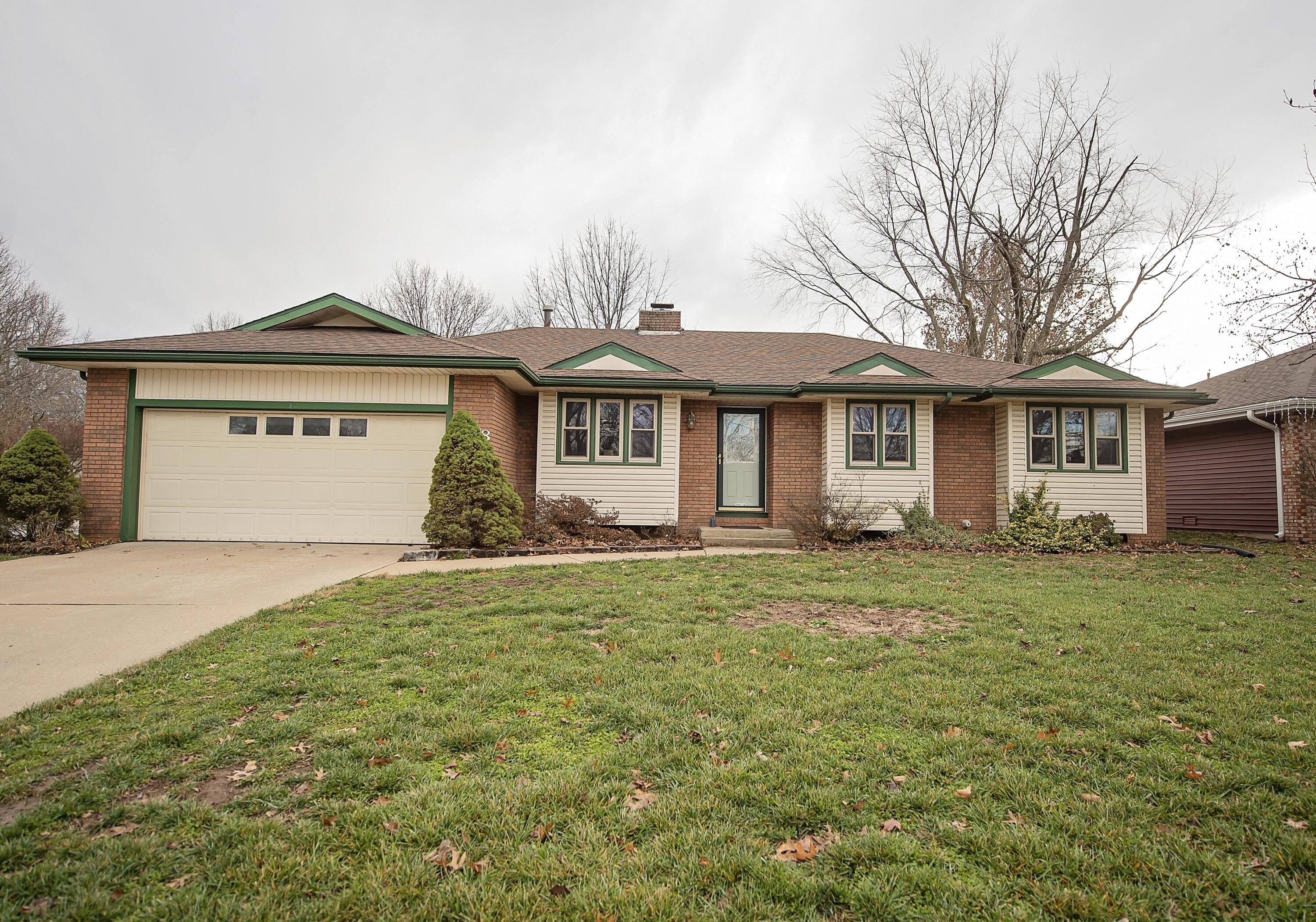 This home has such pretty, custom brick work inside!  A see-through fireplace and brick arches make this more appealing than many!  It has a wet bar, and dining area (room) with a built-in cabinet and over-sized window. This also has an exceptional En Suite.  Not only is this room massive, it also has a great walk-in closet!  Then the attached bath has an oversized walk-in shower.   The corner lot has a double gate for rear-yard access and yard storage!  This is a clean home!  Kitchen has a generous amount of cabinets in a U-shaped configeration.   Come see this unique Parkcrest find!  Close to HyVee and lots of eateries, but tucked in a quiet part of the subdivision.