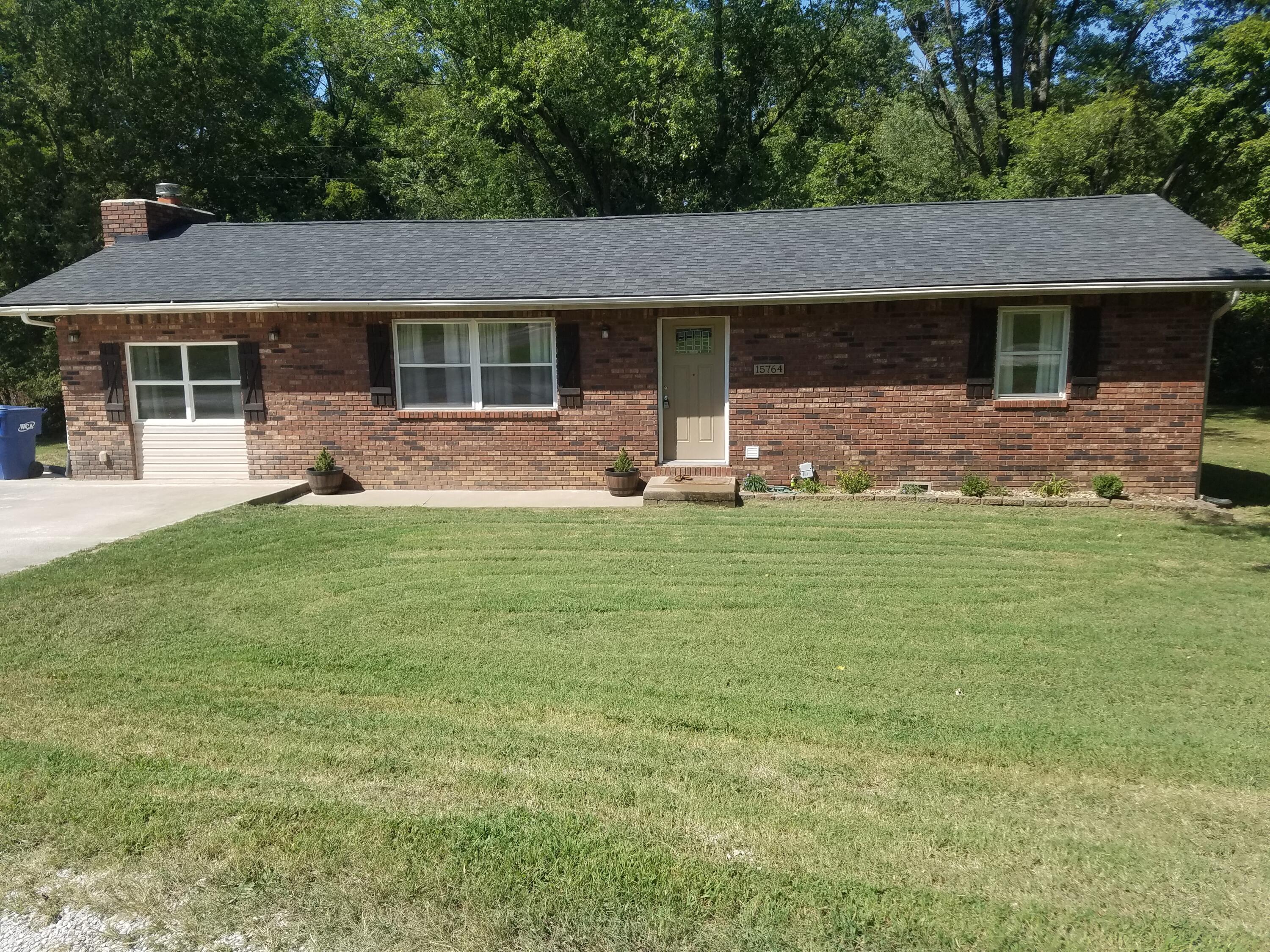 This sweet home is ready for its new family! Beautifully positioned on nearly a half acre lot with mature trees backed by private woods. You will enjoy the tidy curb appeal and shaded back deck. The home is well kept, offers great storage, and includes all of the appliances. The den is a hit with its solid fireplace and natural light. Neosho is a diverse town with a fun historic downtown, new school buildings, and shopping from antique malls to grocery stores!