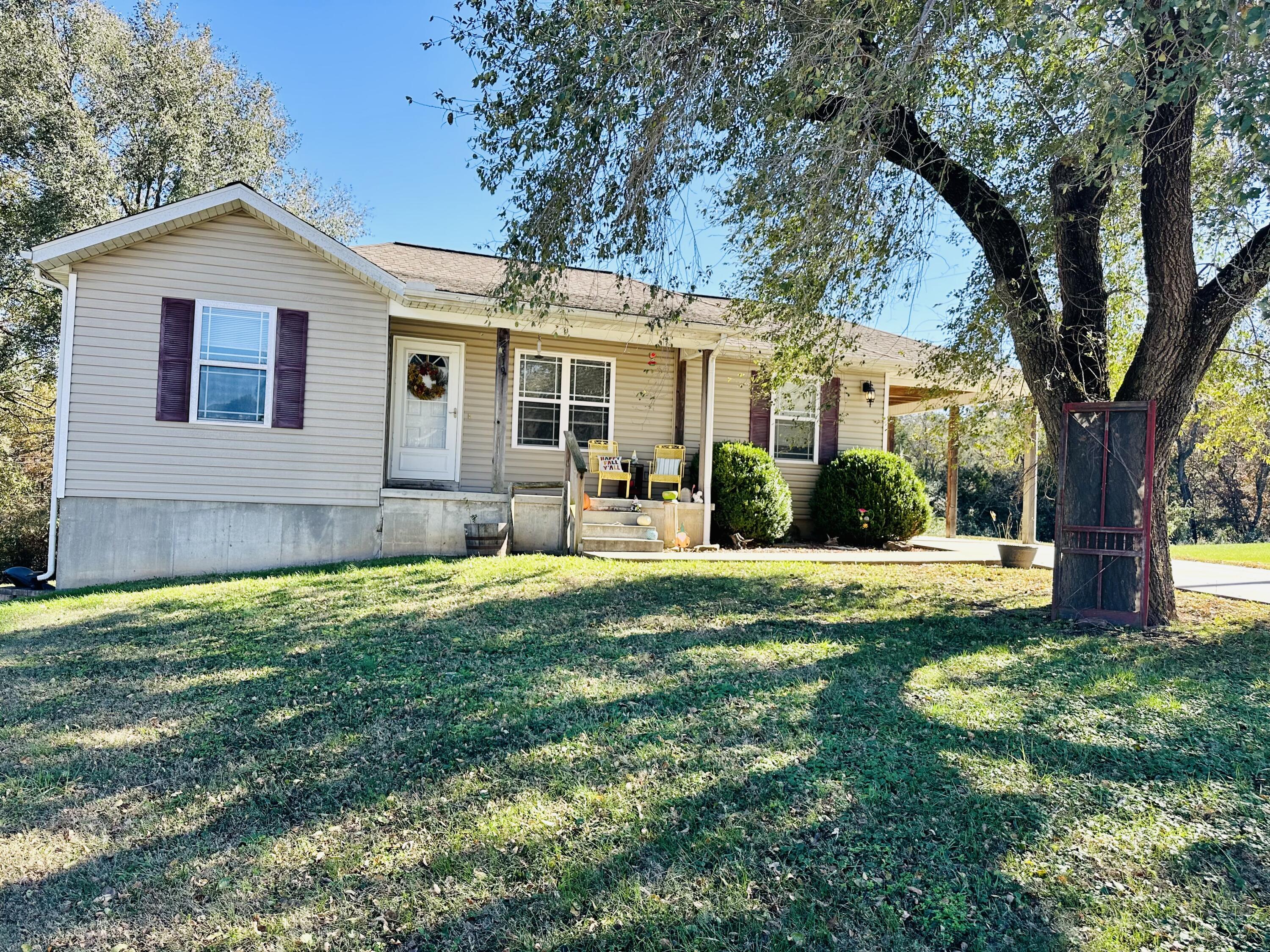 If you are looking for a home close to town, but just outside city limits, you must check this one out! Immaculate 3 bedrooms with a split floor plan, 2 full baths with a full walkout basement that is unfinished but heated and cooled and currently used for a family/game room and storage.  The basement could easily be finished out with a bathroom, bedroom (or 2) and family room, along with a John Deere garage door perfect for a garage or workshop. Outside you will find an attached carport perfect for a car or additional outdoor entertaining space. Several mature trees and 8.36+/- acres. Excellent hunting spot or you could build another home. So many possibilities!