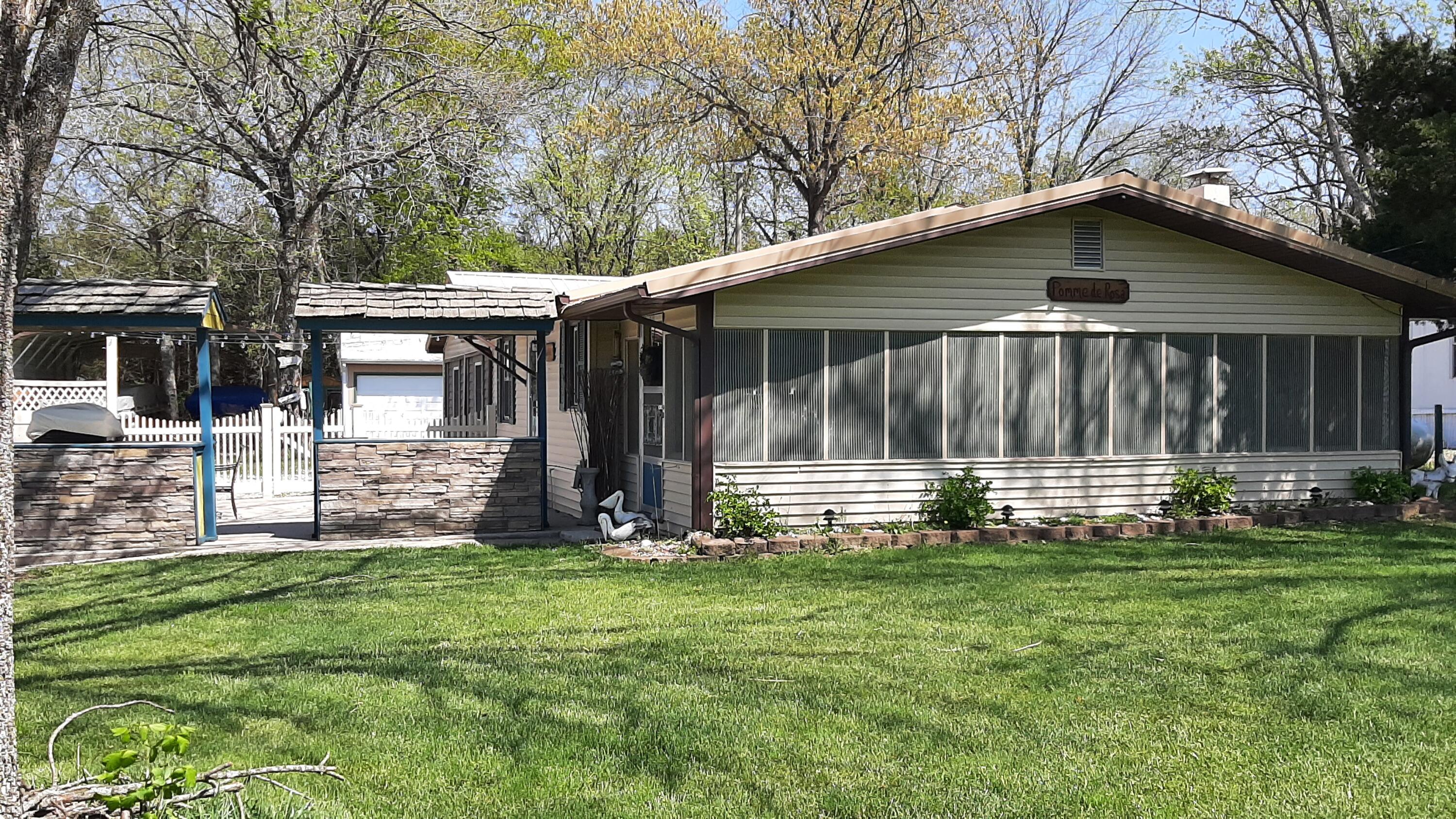 For the buyer looking for an updated beautiful move in ready home with 2 cabins and a shower house for additional guests or vacation rental potential.  This one has it all and the bonus of being nicely furnished!  You are in walking distance to the lake and a great location in the quaint village of Galmey.  The pride in this family owned home is seen in every aspect and feature of this ranch style home featuring a lovely sun room.   The remodeled upscale kitchen was completed in 2020, nice flooring though out and comfort for entertaining, living and relaxing.  In this home, you have 3 bedrooms, 2 bathrooms, sunroom, dining room, storage room, open concept in the main living area, large outdoor area with grill/bar/kitchen,   Pride of ownership shows in this property and is ready for a new owner. So pack your bags and call this one your new home at Pomme de Terre!