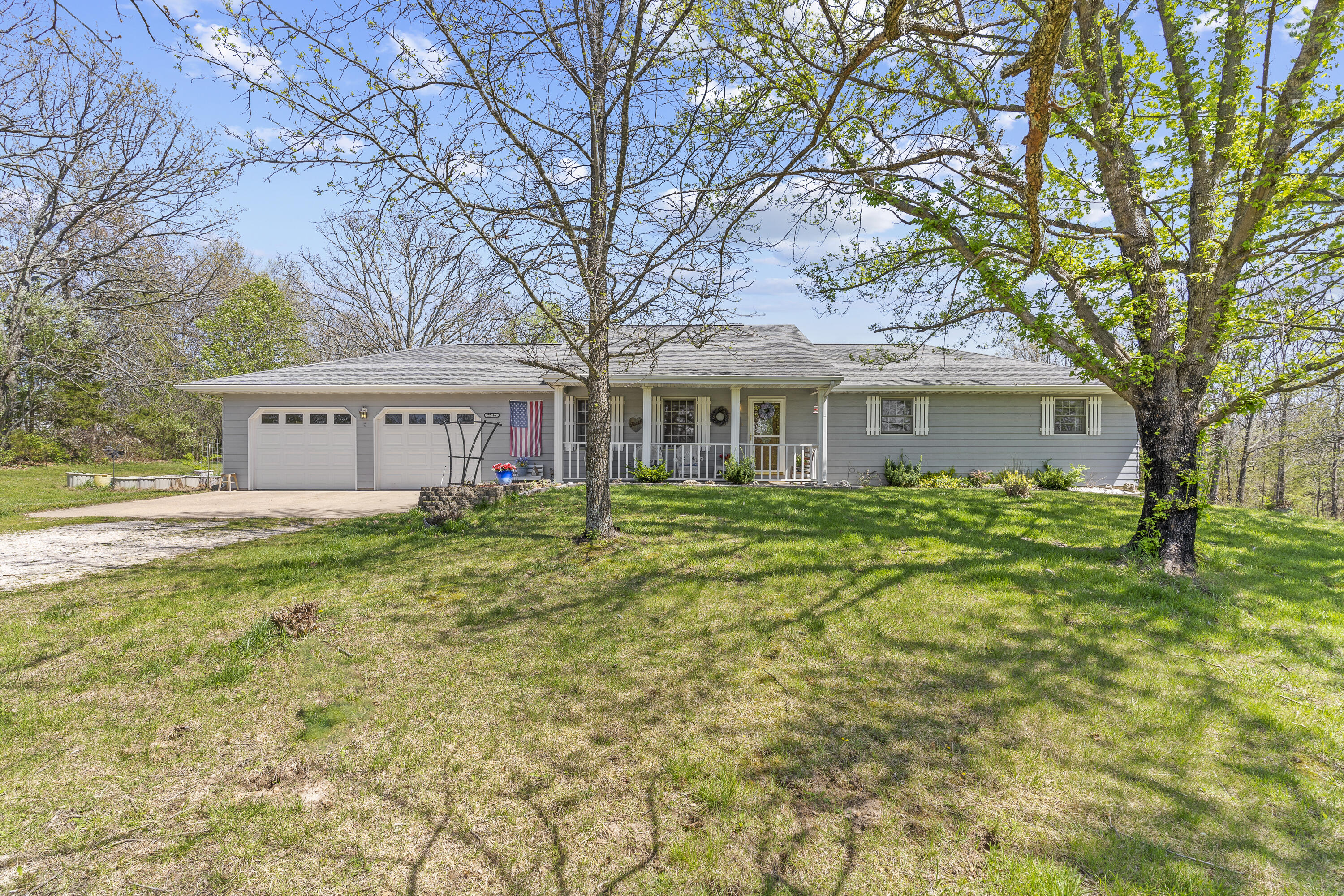 Home Sweet Home! This beautiful 4 bedroom/ 3 bathroom home has so much to offer. Sitting on 5 peaceful acres with mature trees and woods is the first thing you will notice when pulling into the driveway. The front of the home has a welcoming covered front porch to enjoy the scenery. An open concept living room/kitchen, fireplace, formal dining room, and fresh paint are just a few things you will LOVE! The kitchen offers stunning oak cabinets, brand new granite countertops, new black sink, updated lighting, and coffee bar! All appliances stay with the home. Upstairs are 2 bedrooms with new wood laminate flooring, a spacious primary suite, and updated full bathroom.  This walk-out basement home also has a completely finished basement! Downstairs offers a large bonus room with new flooring, a second living room, bedroom, and full bathroom. Need a space to store your boat, lawn mower, or ATV? This home is complete with an extra large john deere room with a sink. Outside has plenty of space to entertain! You can pick between the heated/cooled attached sunporch, covered back patio, or paved outdoor area. This one owner home has been loved for many years and is looking for its next owners. You won't want to miss your chance to own a little piece of paradise! Call and schedule your showing today.