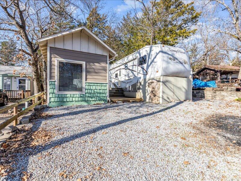 Looking for a great getaway vacation home on Table Rock Lake! Located near Big Cedar Lodge, Yogi Bear Jellystone RV Park offers a public boat launch, swimming pool, tennis & basketball court, and a clubhouse. The spacious lot has room to park your boat, large deck to enjoy the outdoor space. Setup and ready to start spending the summer making memories. 2006 Sunnybrook 40' fifth wheel with 4 slide outs offers plenty of space and lots of storage large living room, electric fireplace. The added bunk house offers additional sleeping space or just a great place to spend looking at the lake view. Storage shed in the back to store all your lake toys. Don't miss your opportunity to have a lake home ready to go for summer of 2022.
