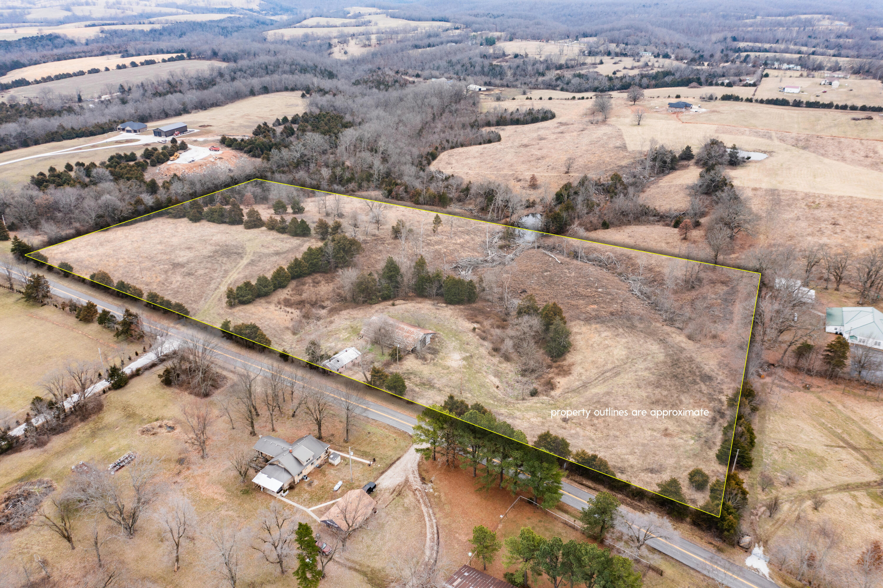 Almost 12 acres of unrestricted country living, only 5 miles from stores and other conveniences!Check out this lovely property located in historic Shady Grove, between Ozark and Sparta. On your 2.5 mile drive from Hwy. 14 down OO Hwy., prepare to be impressed by the beautiful farm land that is blended with gorgeous high-end estates.Once you arrive, the gate leading onto the property is accessed off of a state maintained highway, with very little traffic. The rolling hills offer several great spots to build your own home, or to let your livestock graze. Take in the nice views on the south side of the property, while enjoying the privacy, provided by the lovely tree-line.Additionally, there are two barns, that could be restored, to add to the country charm.Call today, to view the beginning of your future!