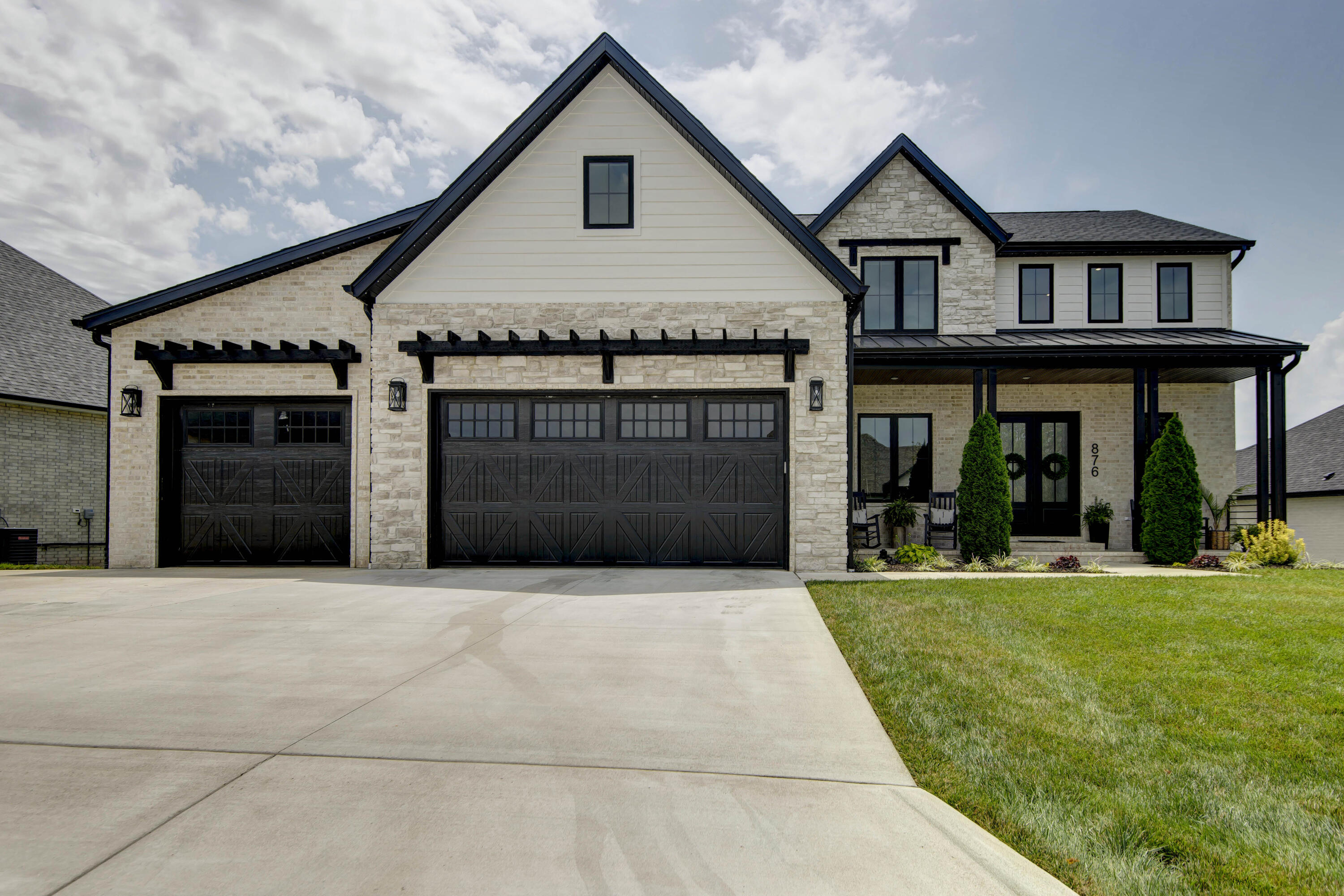 Simply amazing home in Irish Hills Estates!  You will want to put this approximately 5,200 square feet, 2-story irresistible walkout basement home with 6 bedrooms, 3.5 baths, two full laundry rooms, a home office, and multipurpose/play/sunroom on your must-see list!   From the charming exterior with a front porch to the grand 2-story entrance with an iron staircase with a luxury acoustic wood slat wall, you will be wowed by the design and decor the minute you walk through the front door!  This builder's own custom home comes with a long list of amenities and upgrades too numerous to mention. A complete list of features is available on request, but here are a few highlights - a spectacular open floor plan with multiple dining areas and a spacious kitchen complete with a commercial refrigerator & range hood, 2 induction ovens, 2 dishwashers, a built-in microwave, a large walk-in pantry and a handy mud room with built-in bench & storage when entering off the spacious tandem 4-car garage! Other amenities include beautiful hardwood floors, high-end quartz countertops, and tile backsplashes & floors, distinctive lighting & fixtures.  For outdoor entertainment and family fun, enjoy the large deck with a spiral staircase leading to a large partially covered lower patio with pavers.  High-tech features include smart lighting, top-of-the-line, 98% efficiency HVAC with 3 separate units/zones & computerized controls,  two high-efficiency hot water heaters and a water softener. The quality features go on and on... call today to schedule your private showing!