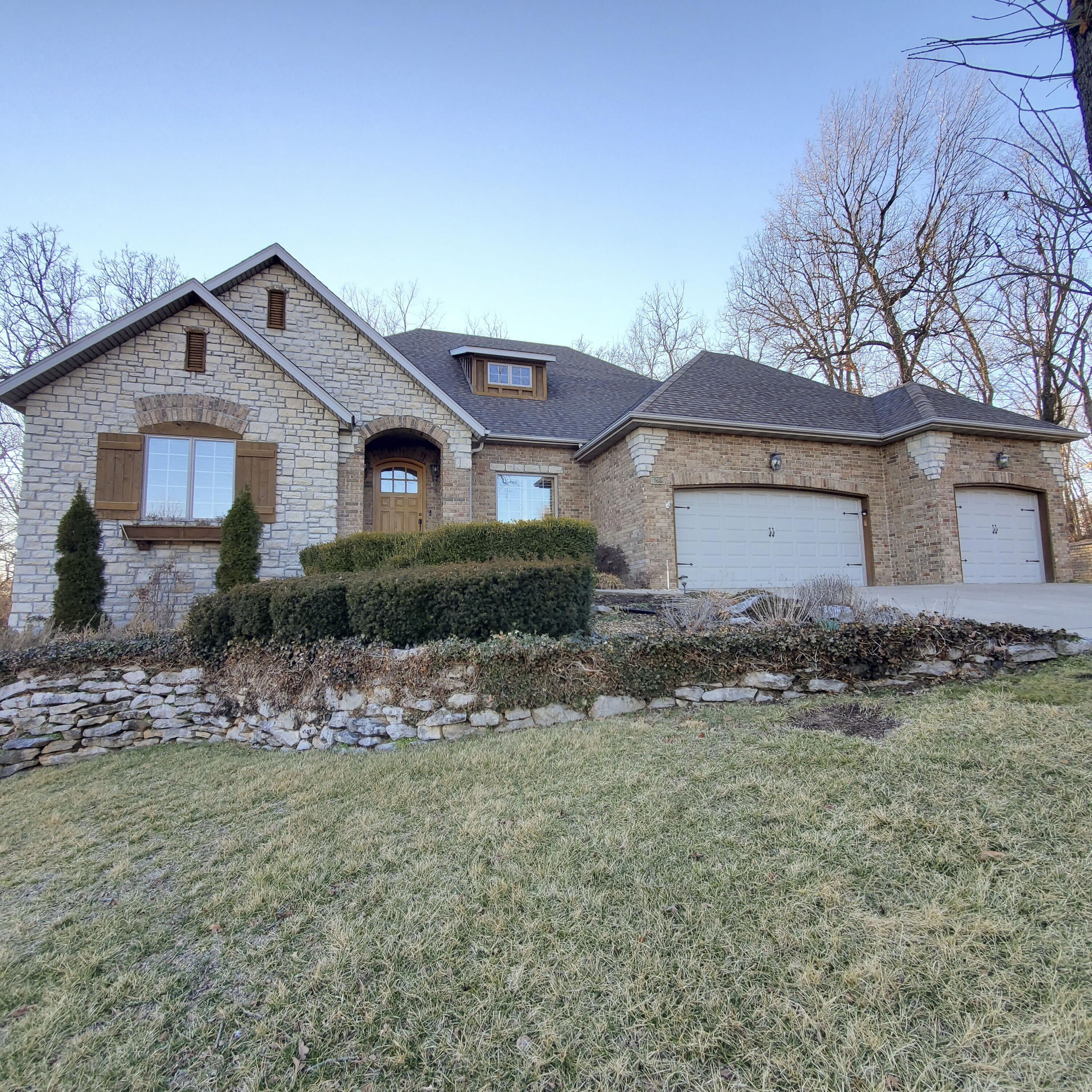 Open Sun Feb 20, 2022 from 2:00 to 4:00...currently, no neighbor in back..(wooded, 10 ac tract ) SE Spfld/ Emerald Pointe.Appr 4500 SF , open kitchen/hearthroom with recent updates. Gas range, double ovens , granite countertops in the kitchen. All brick/stone exterior with a large,covered deck accessible from Kit and Master BR , & stairs leading to the,fenced, backyard. There is a formal dining room upon entering, a 2nd BR or ideal nursery or office, large master BR and bath offering his/hers closets & vanities.Jetted tub and step-in shower. Beautiful plantation shutters cover many of the windows and doors.Updated tile, fireplace 'face',backsplash and paint in the kit/hearth room..surrounded by windows that allow natural light to pour in...and private due to the wooded bankyard.The laundry room, mud bench, half bath, and pantry are on the main level. The wood flooring in the formal dining and living room are recent upgrades. The walkout basement boasts 3 additional bedrooms, (each with bathroom access),a wet bar overlooking a large recreation room and a woodburning fireplace. An additional room appears to be 95% complete; exercise room/crafts/office? Don't miss the storm shelter!  Located on a cul-de-sac /dead end street.