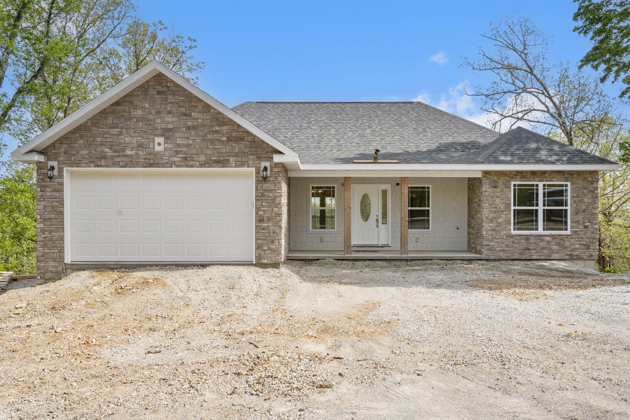 Welcome to quality at it's finest. This brand new home offers approximately 3,200 square feet with five bedrooms, four bathrooms, a dedicated office or sixth bedroom and laundry room on the main level. The craftsmanship is showcased with custom millwork crown molding, quartz counters and an impressive exposed beam ceiling in the living room. The kitchen is open to the living and dining areas and features top-of-the-line cabinets, appliances and fixtures and a large covered deck for enjoying the expansive mountain views. The primary bedroom and bathroom are spacious and the bathroom is complete with a dual head walk-in shower, oversized soaker tub and large closet. The lower level is a great place to relax or entertain with tall ceilings, a wet bar with custom cabinetry and wine rack, two bedrooms, an office or sixth bedroom, concrete storm shelter, storage room and covered deck. Built with comfort in mind, the heat pumps, two electric fireplaces with blowers, spray foam insulation, water softener and two water heaters keep this home comfortable all year. The location is hard to beat with easy access to Highway 76 and Branson Schools. Schedule your private tour today!