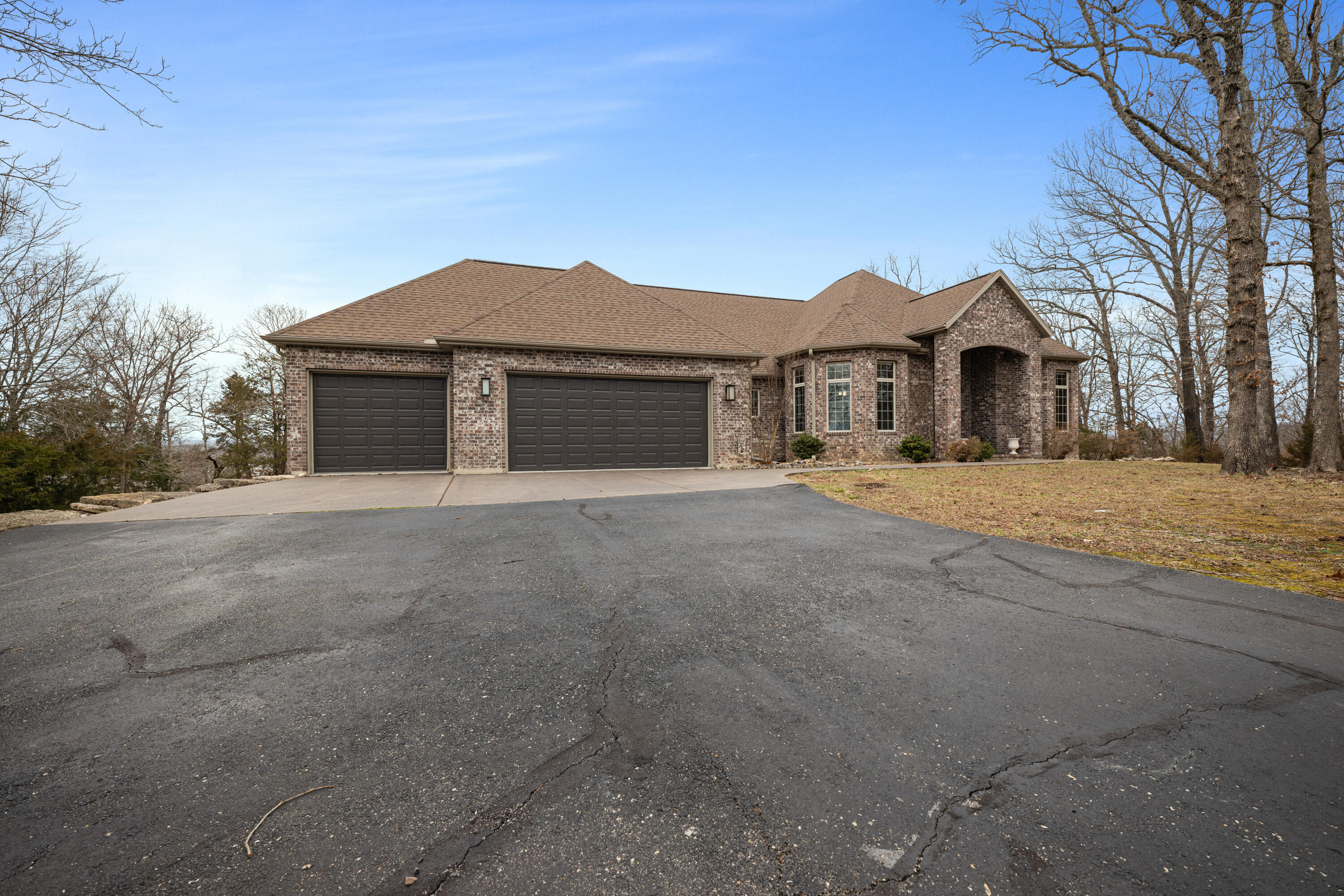 Table Rock Lake View with all the popular features! Sitting on just over 2 acres, this four bedroom, four bathroom with over 4000 square feet under the roof, has been expertly and tastefully updated in a rustic country style with new lighting, flooring, trim, doors, and fixtures. The kitchen as been completely remodeled with custom painted cabinets, custom two tone granite counter tops, and new appliances. All the bathrooms have been updated with new fixtures, flooring, cabinets, tile showers, and the master features a soaking tub. Additional features include a formal dining and an eat-in kitchen island with a custom barn door slider divider in the living room, two screened in porches with Trex decking, feature walls with inset electric fireplaces in the living room and family room which also features a dry bar, a 3 car garage, a fire pit, water softner, and three water heaters. Just short golf ride to the lake and a 10x28 boat slip is available for purchase.