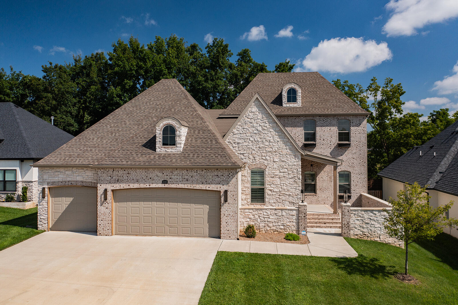 Looking for NEW without the wait for construction? Welcome Home! This home has all of the upgrades and is move in ready! This  gorgeous French Country Home features a welcoming and luxurious courtyard. As you enter the home you will notice the soaring ceilings and beams, open concept kitchen and living spaces, wonderfully treed backyard, expansive main bedroom suite, and bright open spaces. The kitchen features a large island, ample cabinet space, gas cooktop with pot filler, quartz countertops, and cabinets with glass inserts and lighting. Large open concept living and dining area with gorgeous floor to ceiling stone fireplace. Wonderful wall of windows to the backyard with covered patio, outdoor kitchen with gas grill and wok, sink, and granite countertops. Bright and open office space with double french doors off of the kitchen, full bath, bedroom and laundry on separate side of home. The main bedroom suite features door to back patio, large ensuite bath with soaking tub, tiled walk in shower, and large walk in closet.  Upstairs you will find an additional living space, large full bathroom, and three bedrooms with walk in closets. Wonderful front and backyard at this home in Anthony Park that features gorgeous entrance fountain, swimming pool, tennis courts, walking trails, and more. ALL in a phenomenal location. Do not miss this opportunity!