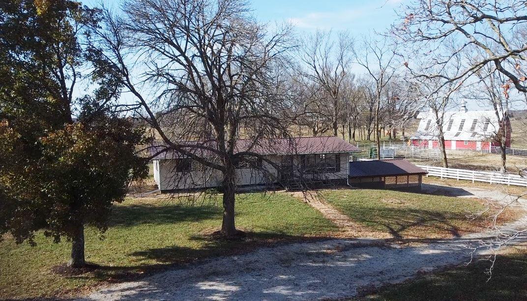 Missouri Farming at its Finest! This 223 Acre Grass Farm is well known for its Operational Farming capabilities focused primarily on Cattle grazing and Hay Production! You may also recognize the Historic 1925 Patriotic Red Barn with custom American Flag Roof that has been a focal point in Cedar County for many years. This Cattle Farm is fully fenced and cross with pipe corners, 4 large pastures set up perfectly for rotational grazing. Additionally, the main pasture set up has access to a shared automatic water at the corners allowing water access to all, 2 additional pastures, cattle working facilities including chutes, corrals and pens. Water is available all over the farm with 2 wells and 4 ponds. The Rustic 1925 Barn has a recently refurbished and unique 30x60 wood loft area plus the original 40x60 main level. Plenty of storage options with a 24x30 Shop with a 24x40 attached Machine Shed. There is also a Manufactured Home on the property with a with Full Finished Basement. 2,496 total Square Ft of Living space. The Main floor consists of an open kitchen, living and dining area, 1.5 baths, 2 Bedrooms and a landing at the stairway large enough for a small office area. The basement has another large living area, bathroom, 2 non-conforming bedrooms and office. There is an attached 2 car carport plus a large deck are for viewing the park like yard. The neighboring views from this farm are also spectacular. You have 9/10 of a mile of Blacktop Highway Frontage and 1/4 mile of gravel road frontage make it the perfect farm to divide for multiple family members to establish their dream. Don't let this Cedar County Beauty Pass You By!!!