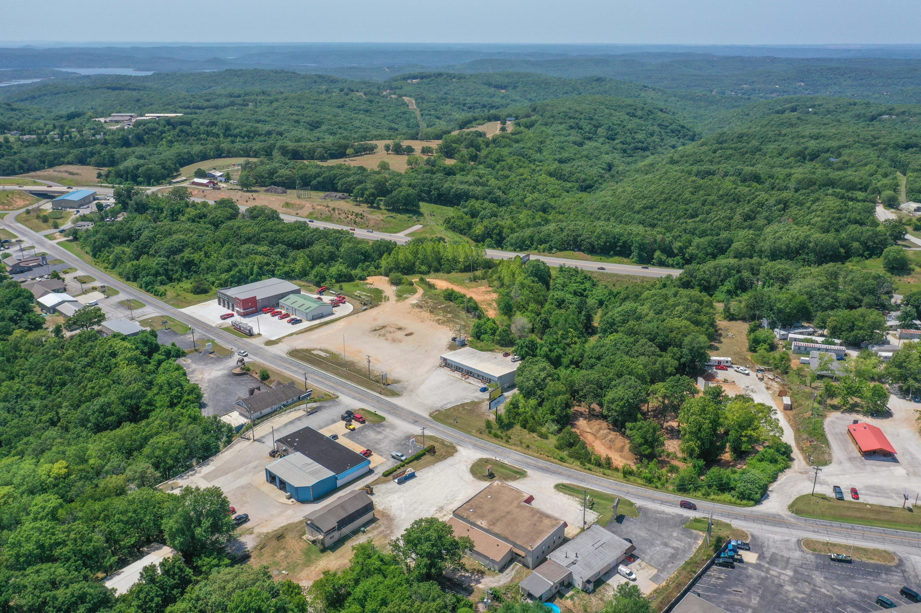 Commercial/Residential Investment Property with +/- 8.49 acres of Exceptional Development Potential!  The existing +/- 10K Sq. Ft building offers consistent income from the 4, 2 bedroom residential units and great upside from 4, commercial units waiting for a new owner's choice of tenant mix or personal use. There are 3 parcels zoned commercial/residential that include several acres of flat to gentle land and over 400 Ft. of Bus. Hwy frontage. Great location for large commercial  operation such as lumber yard, shopping center, self-storage, boat & RV sales.  Outstanding commercial/residential mixed-use potential.  Seller retiring.  Bring offers!