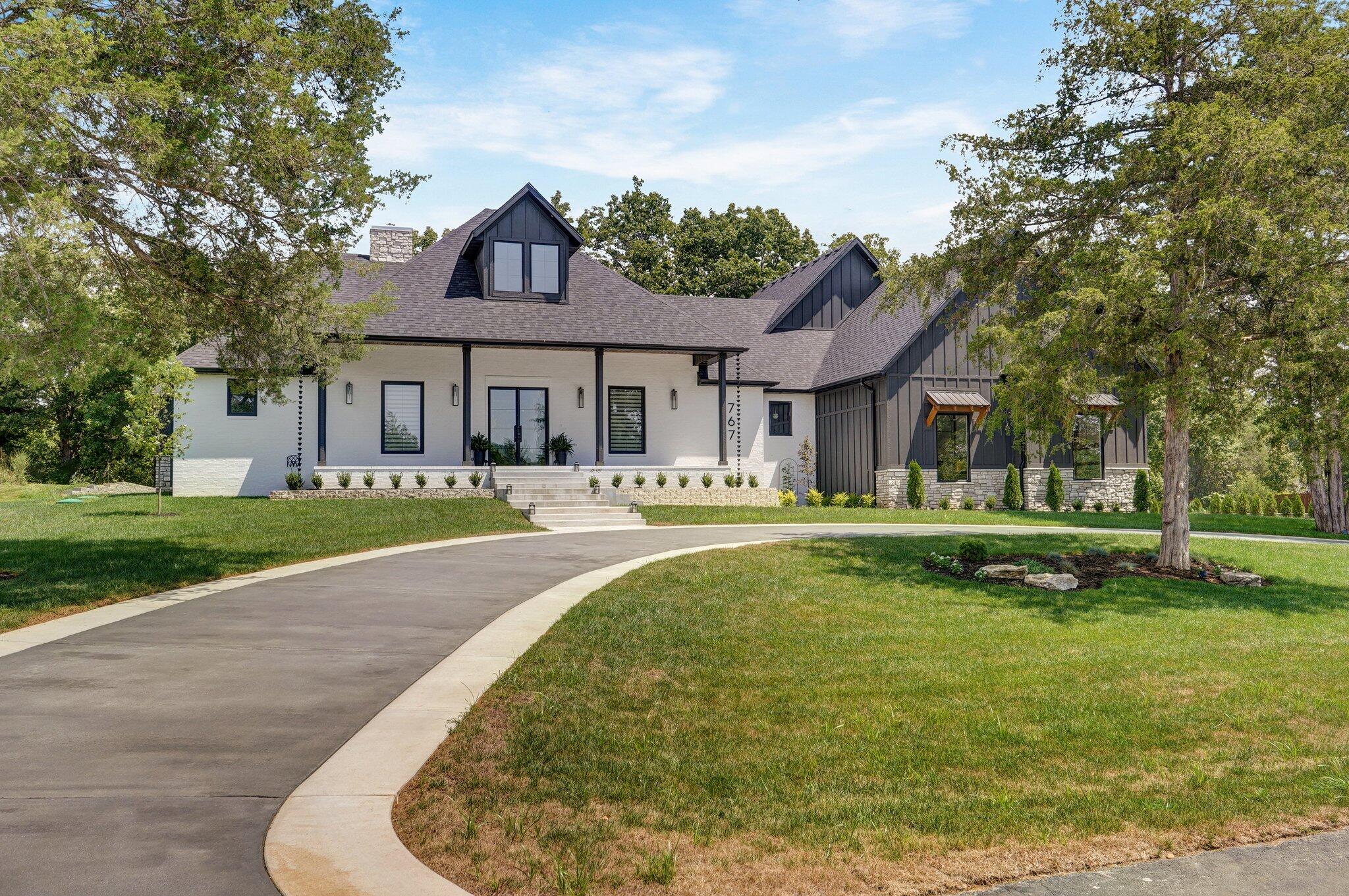 Stunning, luxury home in Saddlebrooke on acreage! This custom 2023 home has high-end features that are meticulously designed to blend sophistication and comfort. As you enter, you will be greeted by the grandeur of 18' ceilings and an expansive open floor plan that extends through the home. The living area boasts 12' ceilings and features a 72'' gas fireplace with a custom heat vent installed above the TV, creating a cozy ambiance. The living area is also equipped with built-in speakers, perfect for entertaining or movie nights! The kitchen is a chef's dream, with high-end appliances, including a Wolf built-in coffee machine. The kitchen also boasts quarts counters and features a stunning waterfall island. The formal dining room has an accent wall and spacious enough for your family and guests! The large master suite also features a custom accent wall with mounted fixtures and a stunning fireplace that brings ambiance into the room. The master bathroom has dual vanity sinks, a soaking tub, heated floors that extend into shower, and a custom-built closet! There are four additional bedrooms, with two of them being ensuites. Additionally, one of the bedrooms is being used as a spa room and has a gorgeous wood-burning fireplace, a seating area and a custom-built wet bar! Just off the spa room, you will find a Finnish, custom-built sauna where you can relax and enjoy the health benefits all in one--wow! The covered outdoor porch includes its own wood-burning fireplace and built-in speakers, a perfect place to lounge in the evenings! Additionally, the porch has a hot tub concrete pad for your future hot tub. Other key features: an extended three-car garage with 18' tall ceilings & steel/glass doors, a separate John Deere door in the garage, ecobee thermostats, German imported windows and doors, laundry room with a doggy shower, high-end fixtures and hardware, see ''Additional Features'' for much more! Adjacent lot for sale if interested in additional land/privacy