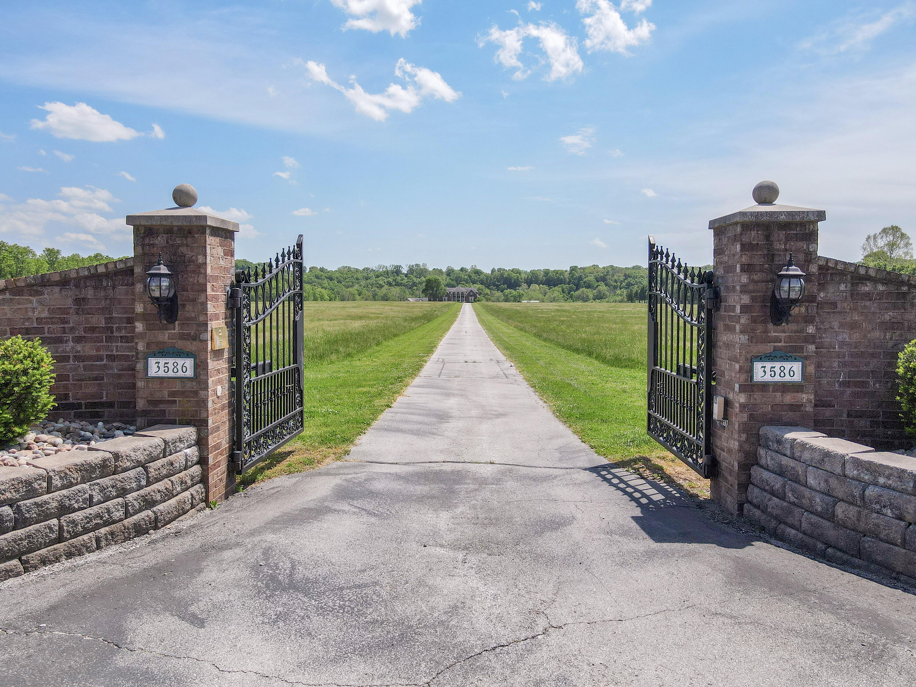3586 McCauley Rd. Nixa MO 65714.  Come see this impressive 45 acre m/l gated estate property located along the Finley River between Ozark & Nixa & just minutes South of Springfield! Inside the impressive 9,000+ sq. ft. home is an impressive foyer with a 2 story living room and formal dining room with a gas fireplace, above there are 3 chandeliers from Italy that line the ceiling. There is also a large kitchen with granite, custom cabinets, a double oven, a Jenn-Aire stove top, plus a walk in pantry. Next to the kitchen is a nice sized hearth room with another gas fireplace. On the main floor is the large primary suite which includes a large ensuite bathroom, private sitting area, and an office. Also, on the main floor is the large laundry room big enough for 2 washers, 2 dryers and a washing sink.  Upstairs are 5 bedrooms plus a bonus room. One of the upstairs bedrooms has its own bathroom and the 4 bedrooms have a Jack and Jill bathroom between them.  The basement is wide open with multiple living areas and perfect for all of your recreation needs: pool table, ping pong table etc, with a State of the art custom made bar that is the focal point of the basement.  The walkout basement will take you to the outdoor stamp concrete patios and the inground pool with a retractable cover and outdoor kitchen.  Also, out back is the 20 car garage shop with 10 bays each long enough for 2 automobiles,. The ground level is over 6,200 sq. ft. and up stairs on one half of the shop is 2 large bonus rooms for all of your hobbies, and on the other side of the shop upstairs are living quarters with a living room, kitchen/dining area and 3 bedrooms with closets (no windows in bedrooms) plus a full bathroom and a laundry room. The entire shop / garage is heated and cooled.  Farther back on the property is a horse barn with 4 indoor stalls and 4 indoor/outdoor stalls with corral panels. This is a well maintained one owner custom built property with so much to offer.