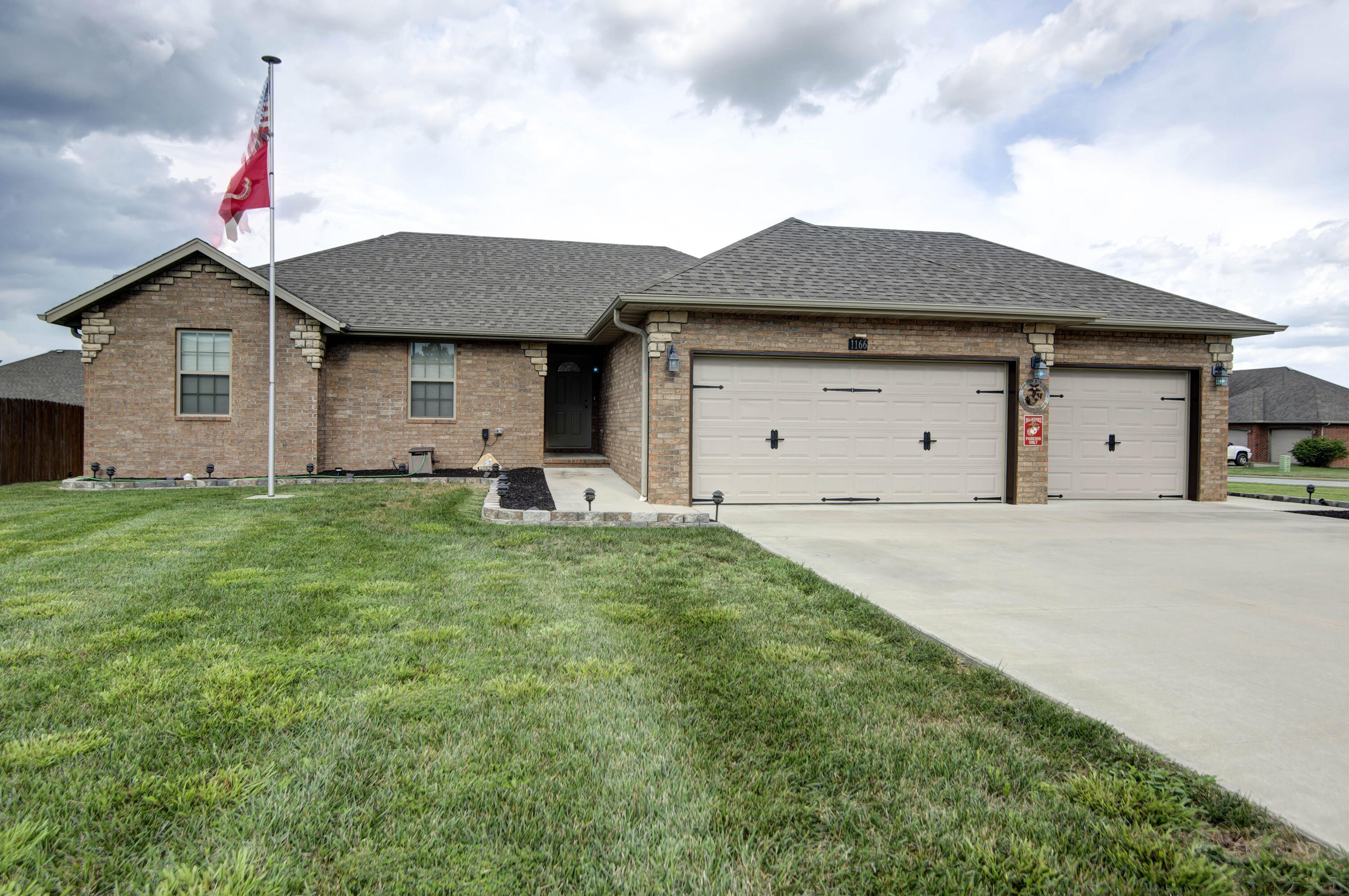 Nothing builder grade about this home!  This immaculate, one owner home is custom all the way!  Truly a showplace!  Featuring an  open floor plan with kitchen and dining open to the family room - beautiful, elevated ceilings - 3 bedrooms  - 2 full baths.  So many upgrades and special features including; granite counters in kitchen with new composite, undermounted sink - eating bar - stainless steel refrigerator, washer and dryer are included - elegant bathrooms with granite countertops - tub/shower in hall bath - spacious walk-in shower in master with his and her closets and dual vanity - upgraded new toilets, bathroom sinks and faucets -  laminate and hardwood flooring in family room, dining room, hall and bedrooms - tile in bathrooms - all custom draperies remain with home - 90+ energy efficient HVAC - attached 3 car garage with insulated walls & doors and flooring above garage - storm shelter in garage - lovely stone and brick front - exquisite composite deck with wrought iron railing & powered awning - posts and deck steps with lighting -additional small patio off of deck - professional, inground exterior lighting on 12 volt system - beautifully lit flagpole - gorgeous, stone landscape rock border with black rubber mulch on all 4 sides of home - very neat, composite fence encloses trash dumpster -  corner lot - quiet street - neighborhood swimming pool - Republic schools.  Call today to make an appointment to see this very special home!