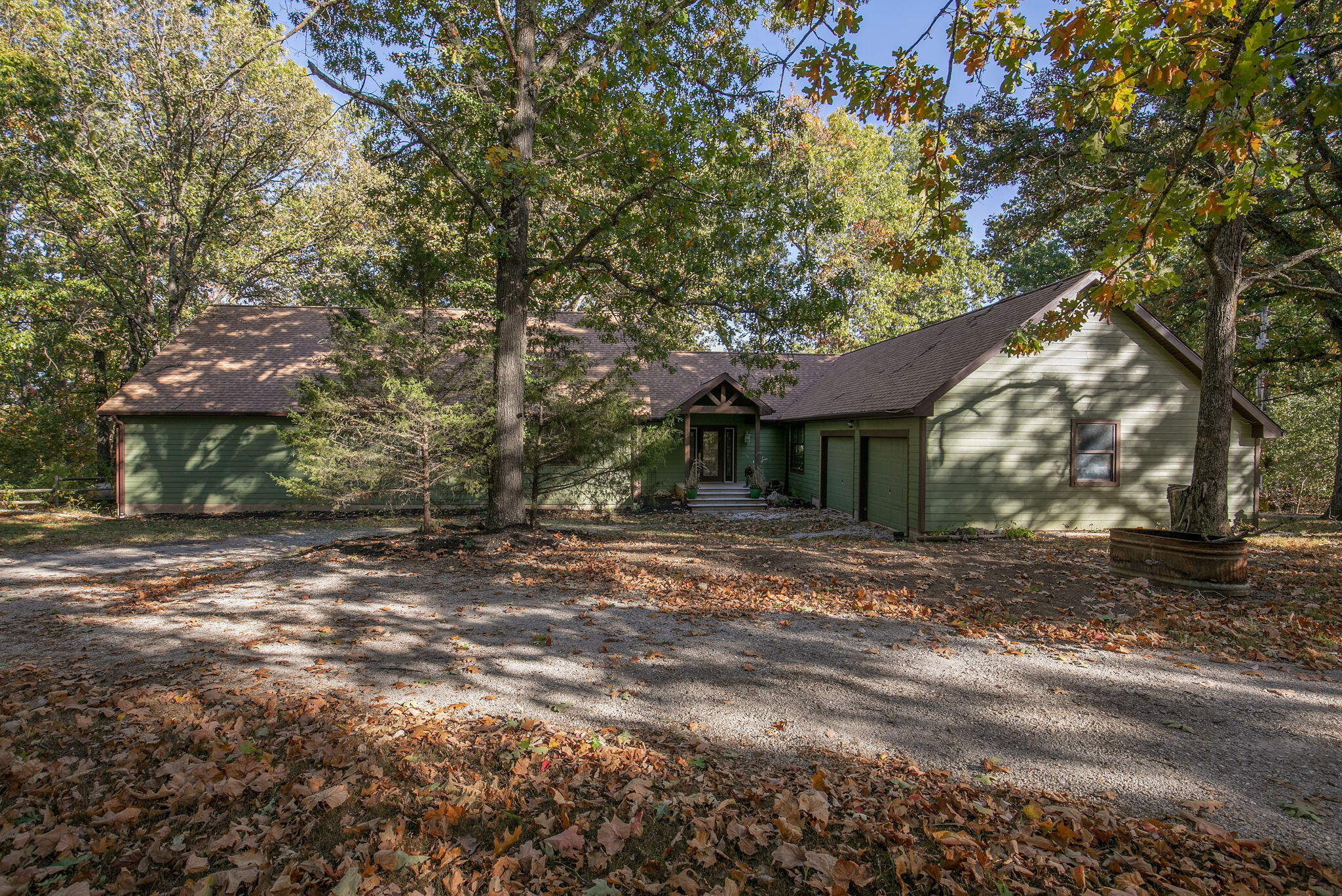 Horse Ranch for sale on a private and Beautifully Secluded area of Rogersville, MO on 14.9 acres. Come and live your Best Life at the end of Pedelo Lane!Enjoy this custom remodeled 3 bedroom 2.5 bath home nestled in your own little wooded oasis. Primary Bedroom was added on during the remodel in 2012 and features full-length windows on the north side which allows you to enjoy the views of the woods and all the wildlife! It also features Vaulted Ceilings, Custom Built-In Bookcase w/Ladder to the bedroom's second level where you will find an additional storage room and reading nook. The primary bedroom also features a huge walk-in custom closet with a massive 8 ft Island, a gorgeous large chandelier, and custom cabinetry. The double-door laundry station is located inside the primary closet. The primary bathroom was also updated in 2012 and features 2 separate sink areas, a vanity area, a Soak-in spa tub, a huge walk-in custom tiled shower with double shower heads, tinted glass walls, and tiled floors. In the Kitchen, you will find a stunning 12 ft kitchen island with gorgeous Silestone countertops. The Kitchen also features a large pantry room, gas range cooktop, double electric oven with a convection oven option, and custom-created cabinets with soft-close hardware. Walking out the back door off of the kitchen you have plenty of space to entertain guests with your picturesque wooded landscape and enjoy your large and partially covered wrap-around deck that is just perfect for grilling with the area being bricked off making it feel custom built for your outdoor grill or Blackstone! This property also features a charming and fully remodeled guest house which features 1BR /1BA and an additional living area/office space which would be perfect for your in-laws, entertaining guests, or could be a potential rental.Your property also boasts a 10 stall horse barn, indoor riding arena and a foaling barn.