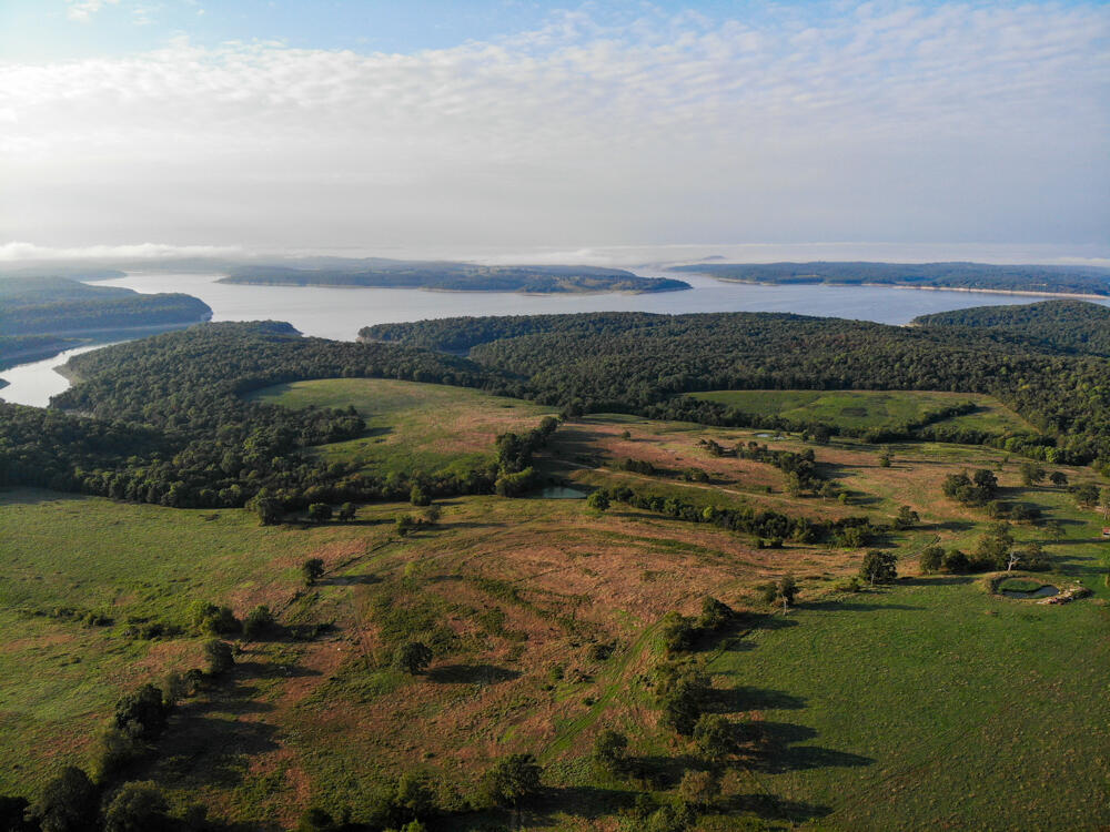 Checkout this picturesque waterfront property on Bull Shoals Lake that checks all the boxes! Entering the property you'll park on an old homestead where there is electric and a well that lines you up for a breathtaking view of Bull Shoals Lake, an absolutely perfect spot to build a home. As you continue into the property you'll notice the rolling hills, diving in and out of the timber only continuing to offer incredible scenery. Sporting 180 acres of pasture and 80 acres of timber this farm remains diverse enough to graze cattle and also have plenty of room to hunt as wildlife is more than abundant. The farm also offers other building sites, 3 entries, cattle right fencing, some cross fence, 4 ponds, a steel pipe corral, an outbuilding with 3 stalls and multiple wet weather creeks. The potential this property has isn't found very often, give me a call to schedule a showing now!