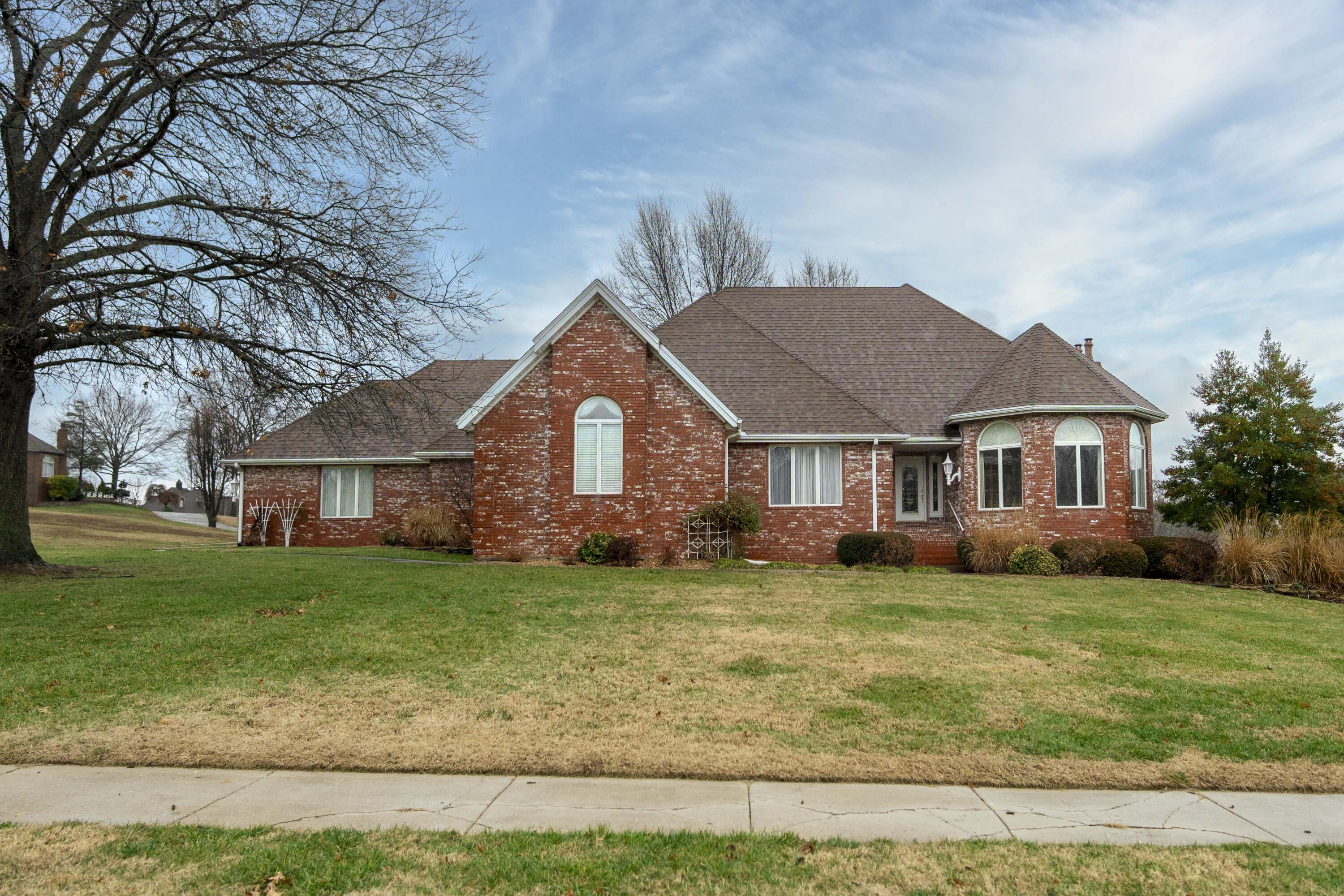 3925 E. Turtle Hatch Rd., Springfield, MO. - Located in The Terraces, a beautiful gated community in Southeast Springfield! This 4 bedroom all brick finished walkout basement home with a side entry 4 car garage offers large open rooms throughout - approx. 6,900 sq.ft. per appraisal. Living room has an abundance of windows to enjoy the great views of the pond. Main floor primary suite plus an additional main floor bedroom with two additional bedrooms on the lower level. Fantastic storage space plus more space that could be potentially finished. Large kitchen with granite countertops, two fireplaces plus 3 living areas! Priced to sell. Nov. 2023 appraisal on file for $745,000!