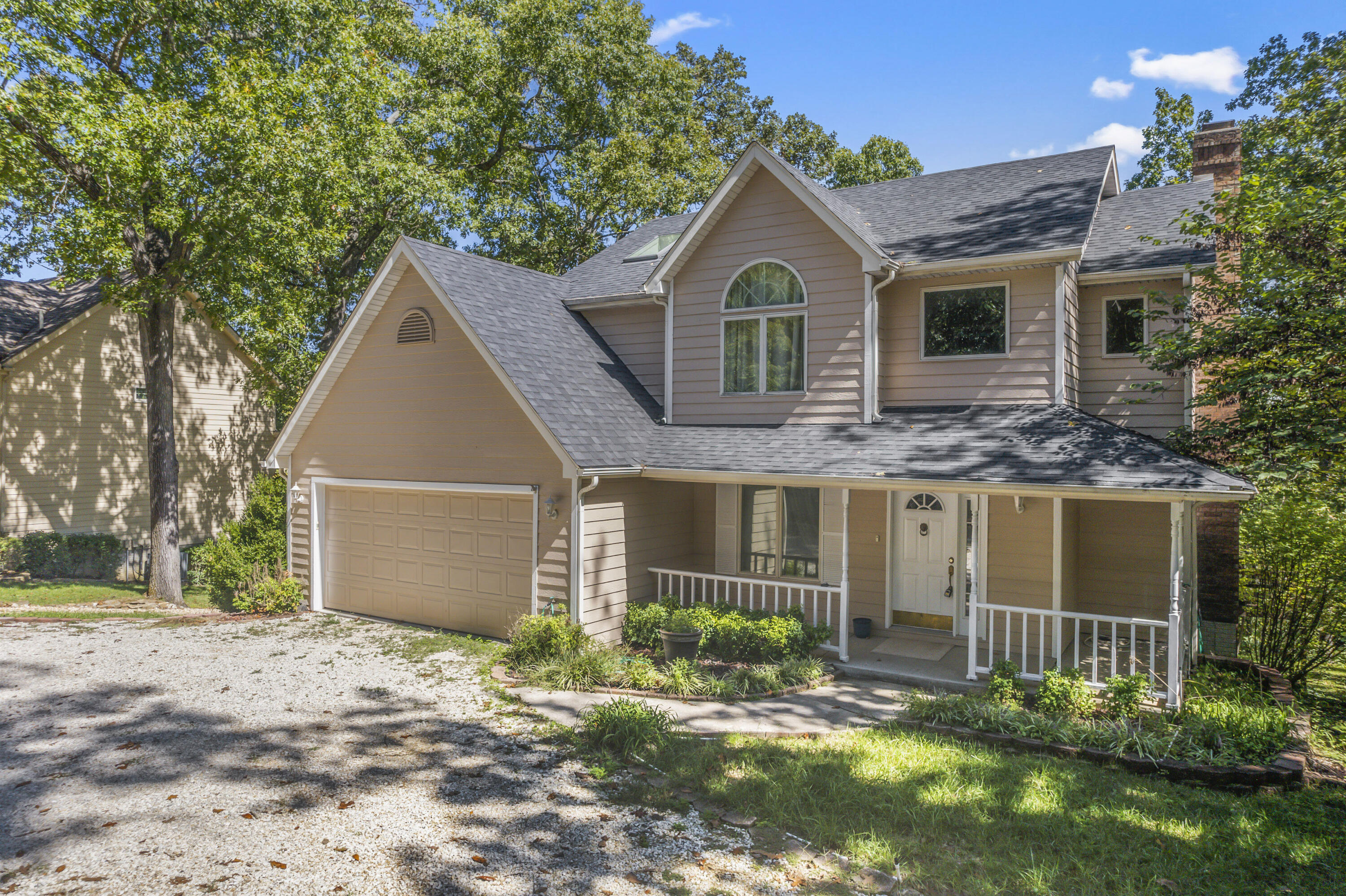 Lake living at it's best....Walk to the Lake!!! This beautiful 4-bedroom home has so much to offer. The home is located minutes away from the town of shell knob. If you are looking for a place that is located in a nice neighborhood and allows you to enjoy the lake this is the home for you. As you pull in you will enjoy the nicely landscaped front circle drive.  Then as you enter the home into the grand entryway you will enjoy a large living room a formal dining room a large eat in kitchen with access to either an outdoor deck or a closed in sunroom that both overlook the lake. There are two wood burning fireplaces, one located on the main floor, and one located in the basement. This will help to cut down on heating costs in the winter. As you enter the basement you have plenty of room for entertaining with a large living room a small kitchen and 1 bedroom and a full bath. The basement also allows you access to enjoy the outdoors with 2 lower patios. This space can also be used for separate living quarters if that is something your family is looking for. The Upstairs offers you 3 bedrooms and 2 full bathrooms. The 3rd bedroom also has the availability to be expanded into a small nook or extended closest the possibilities are endless.  This home also has a boat slip that is available for an additional cost $$. The boat slip is conveniently located just a short walk to the lake's edge right behind the home. This home will not last long.