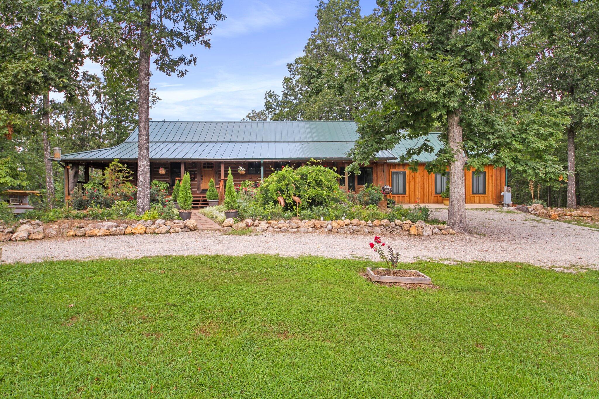 Sellers relocating so extreme price reduction.  An amazing opportunity to own your own stunning private retreat. Located just minutes from West Plains Missouri and bordering the Mark Twain National Forest; welcome to Star Ranch. Nestled down a long private driveway, this beautiful 4 bedroom 3.5 bath  custom built log home has everything a  person could ask for.  With granite counter tops, vaulted ceilings, a long covered porch,  hickory hardwood floors, open floor plan and a new master suite, this home is ready for your family. There is also a bonus room that would be great for a recreation room or home school area.  With a master suite on the main level and a maser bedroom on the basement level, there is room for everyone.  Both have private entrances. The property consist of 83.4 acres with a  50/50 split of pasture to woods and backs up to the Mark Twain  National Forest  on 2 sides.  There are 2 spring fed ponds, a 50 x 50 barn and 30 x 40 garage/shop with a wood stove.  The property also has a new chicken run, garden areas, fruit trees, 3 horse runs with cover and  a new dog run. completely self contained.    The home is very energy efficient and is equipped with a Hardy outdoor water boiler. Lastly the property is private and has numerous additional updates and features including a  covered wraparound porch for those beautiful Ozark evenings. This is must see property.  Call for a private showing.