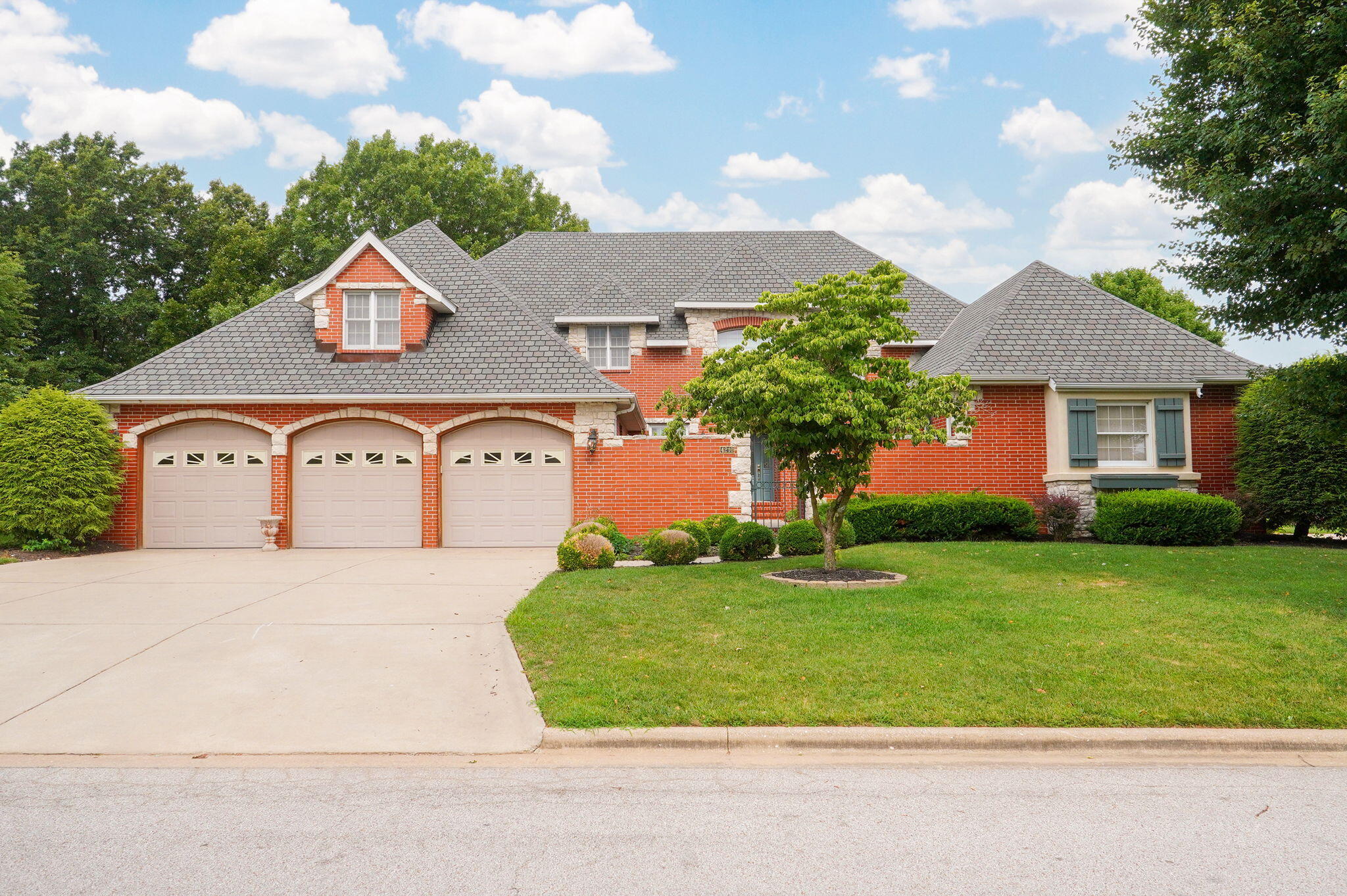 Welcome to 4210 Greenbriar Drive in Fremont Hills, MO. This one of a kind Engel-Middleton home has been treasured since 1994 by the same owners. Built with so much quality and personality in its time, it is amazing how it will suit today's discriminating buyers. It also sits on the 13th fairway of Fremont Hills Golf Course, right by the ''Signature Tree''.  The entrance of the home features a court yard to greet you and the builder used hand cut stone on the exterior to accent the brick. Inside the front entry with soaring ceilings and walls of windows, you can enjoy 2 living areas, a formal dining room and large eat in kitchen, the ample cabinetry along with granite countertops and stainless appliances make this kitchen welcoming and updated. A main floor master suite with rounded ceiling features and a huge bathroom with walk in shower and jetted tub will be the perfect evening get away. Also on the main floor is another bedroom with its own bathroom. Up the dramatic staircase there are two large bedrooms and a Jack and Jill bathroom to enjoy. The views from your two covered patios in the back is where you will want to spend your evenings, sipping on a beverage, watching the golfers go by. Other facts and features are the roof and double HVAC units are approximately 10 years old, there is a central vacuum system and a main floor laundry room. Fremont Hills is an incorporated City with ordinances that can be found at fremonthills.gov .There is no HOA and you do not have to be a member of Fremont Hills Country Club to live in the beautiful and welcoming community.